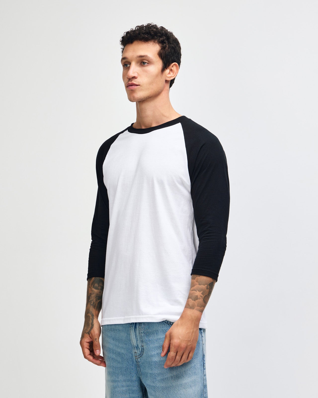 Male model wearing American Apparel CVC unisex raglan Tee (front pose) -white