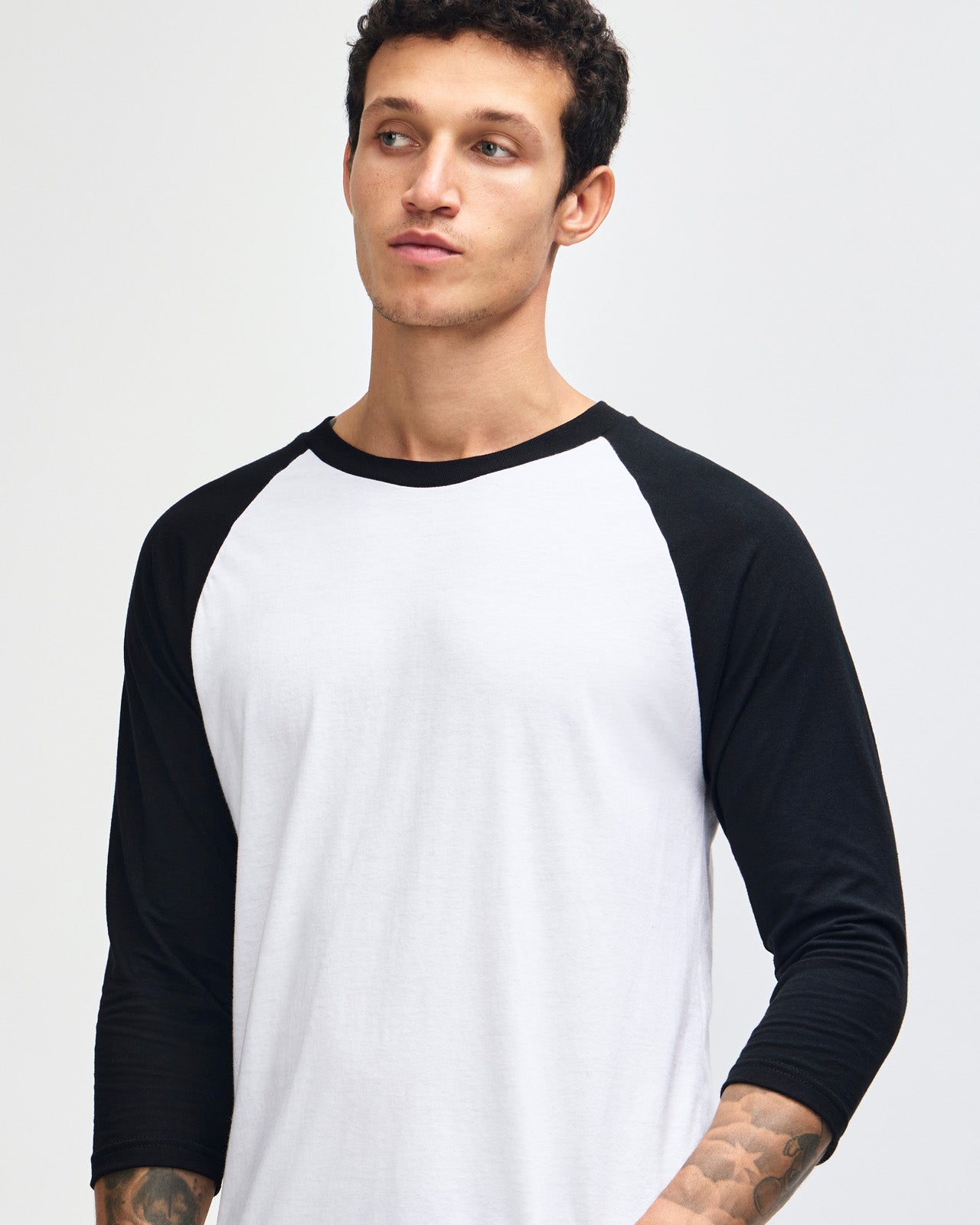 Male model wearing American Apparel CVC unisex raglan Tee (front pose) -white