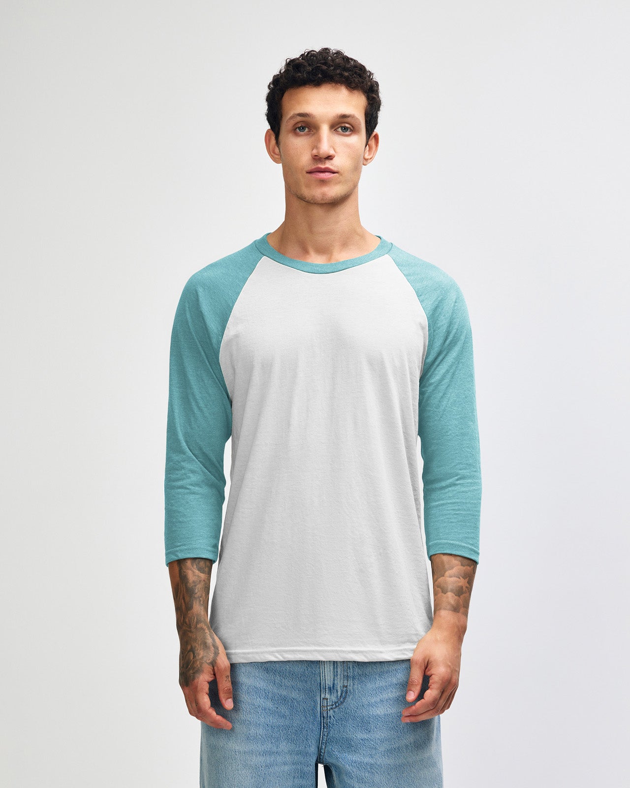 Male model wearing Heather Arctic American Apparel CVC unisex raglan Tee (Side pose) -heather arctic 