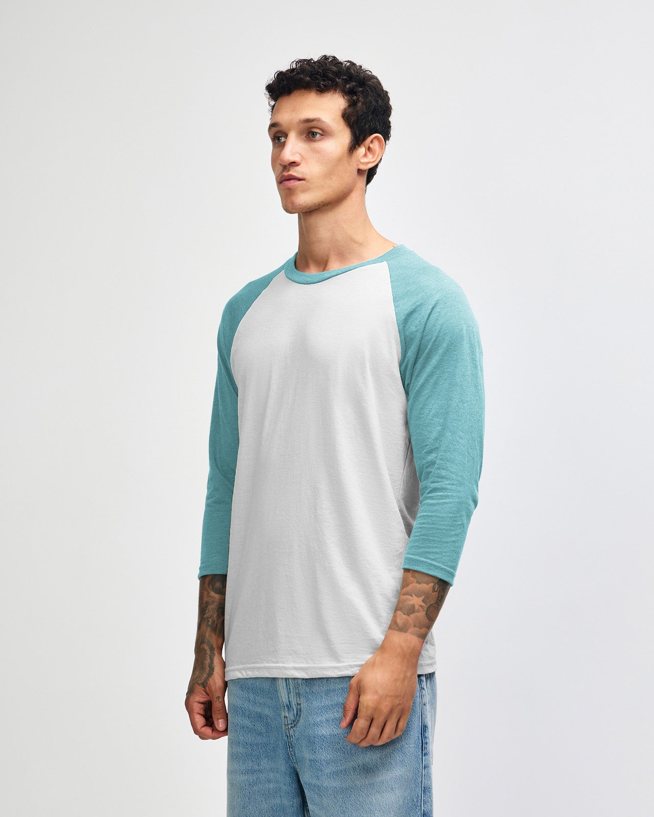 Male model wearing Heather Arctic American Apparel CVC unisex raglan Tee (Side pose) -heather arctic 