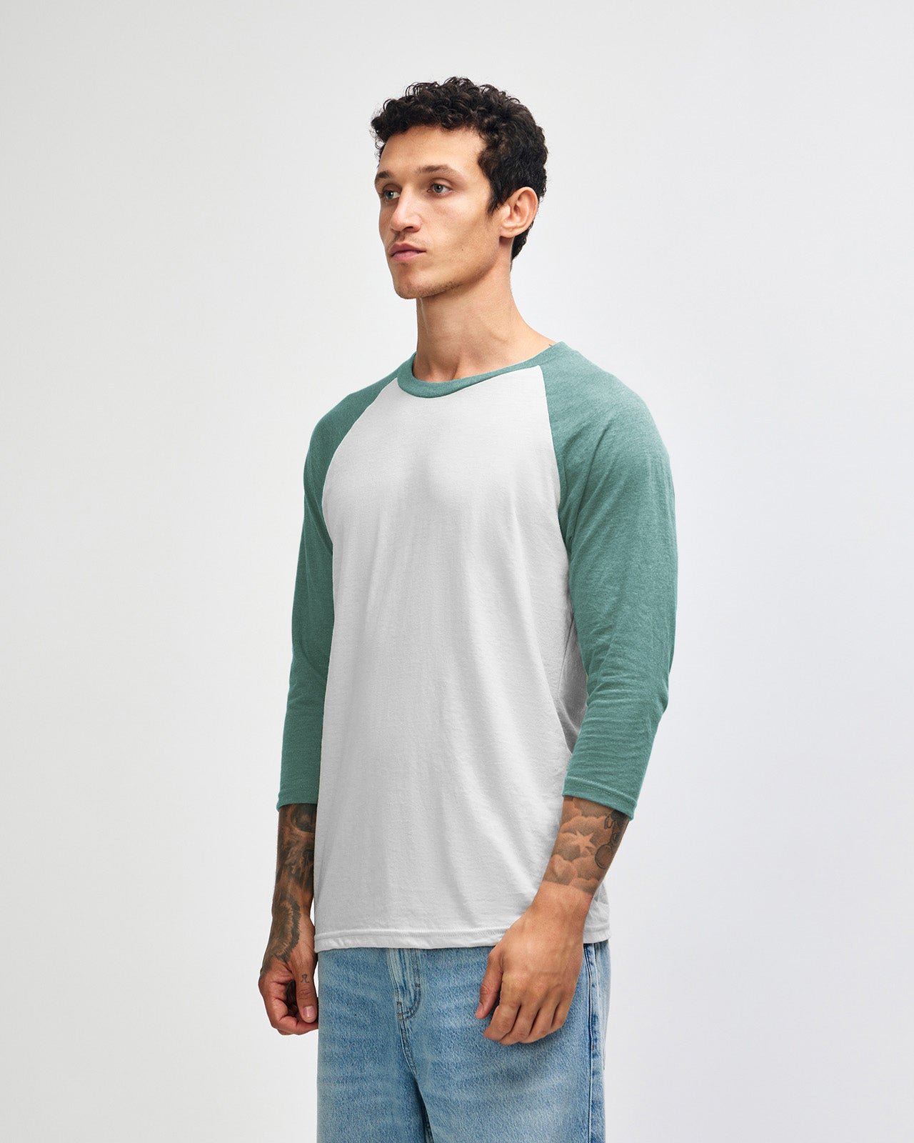 Male model wearing Heather Arctic American Apparel CVC unisex raglan Tee (Side pose) -heather arctic 