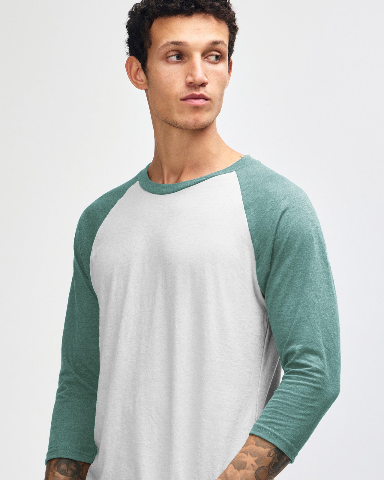 Male model wearing Heather Arctic American Apparel CVC unisex raglan Tee (Close up pose) -heather arctic 