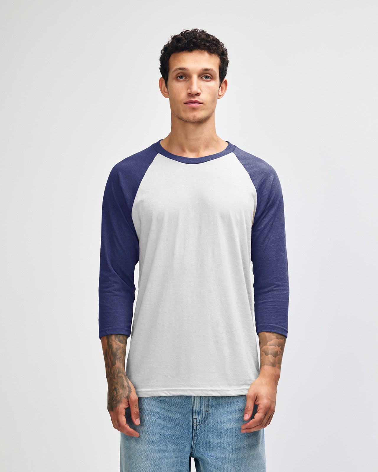 Male model wearing Heather Indigo American Apparel CVC unisex raglan Tee (front pose) -heather indigo 