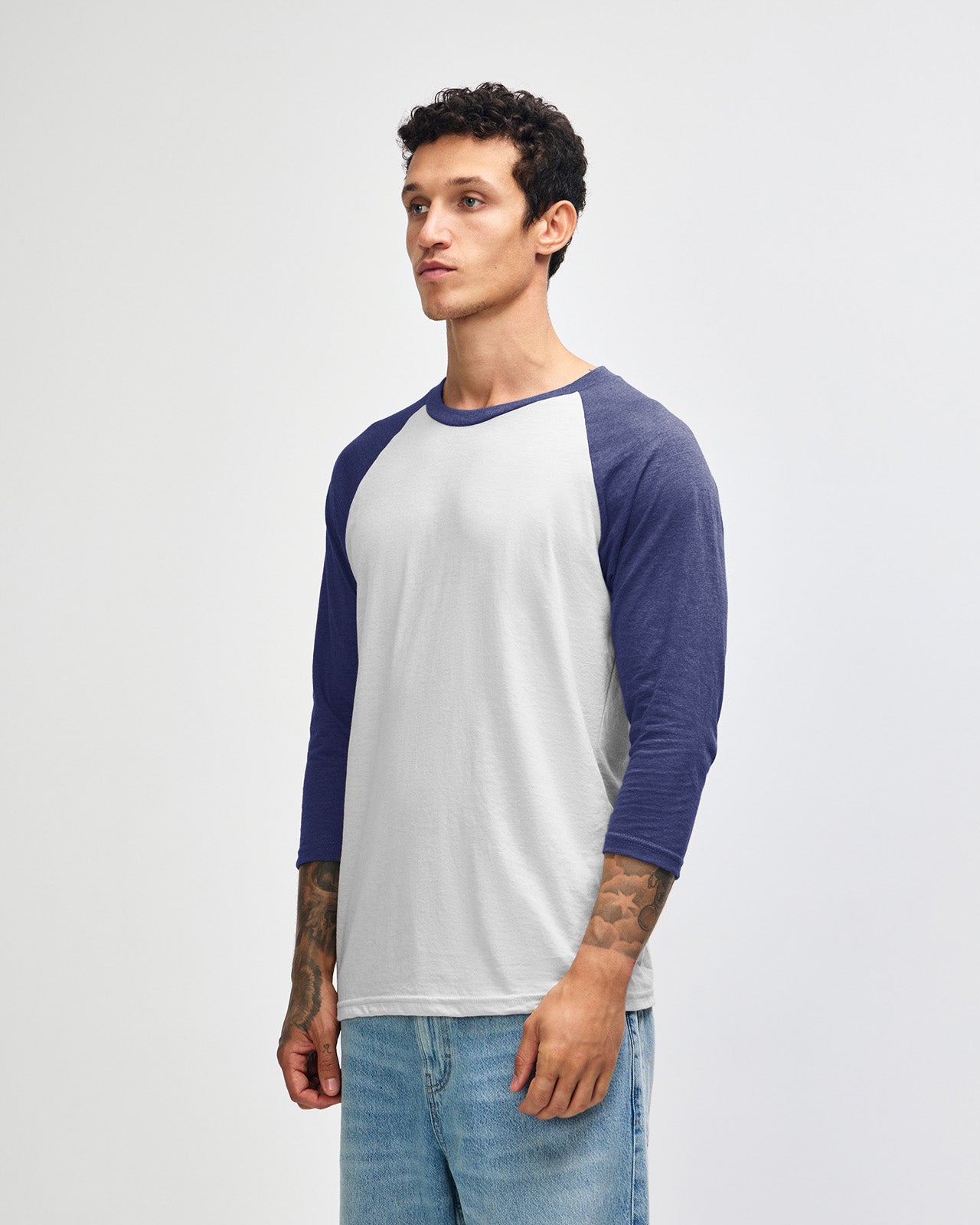 Male model wearing Heather Indigo American Apparel CVC unisex raglan Tee (front pose) -heather indigo 