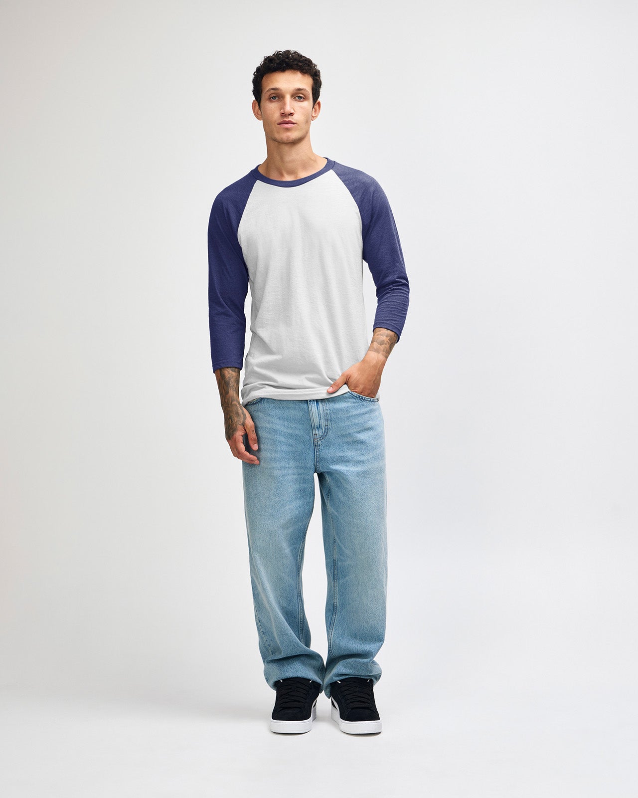 Male model wearing Heather Indigo American Apparel CVC unisex raglan Tee (front pose) -heather indigo 