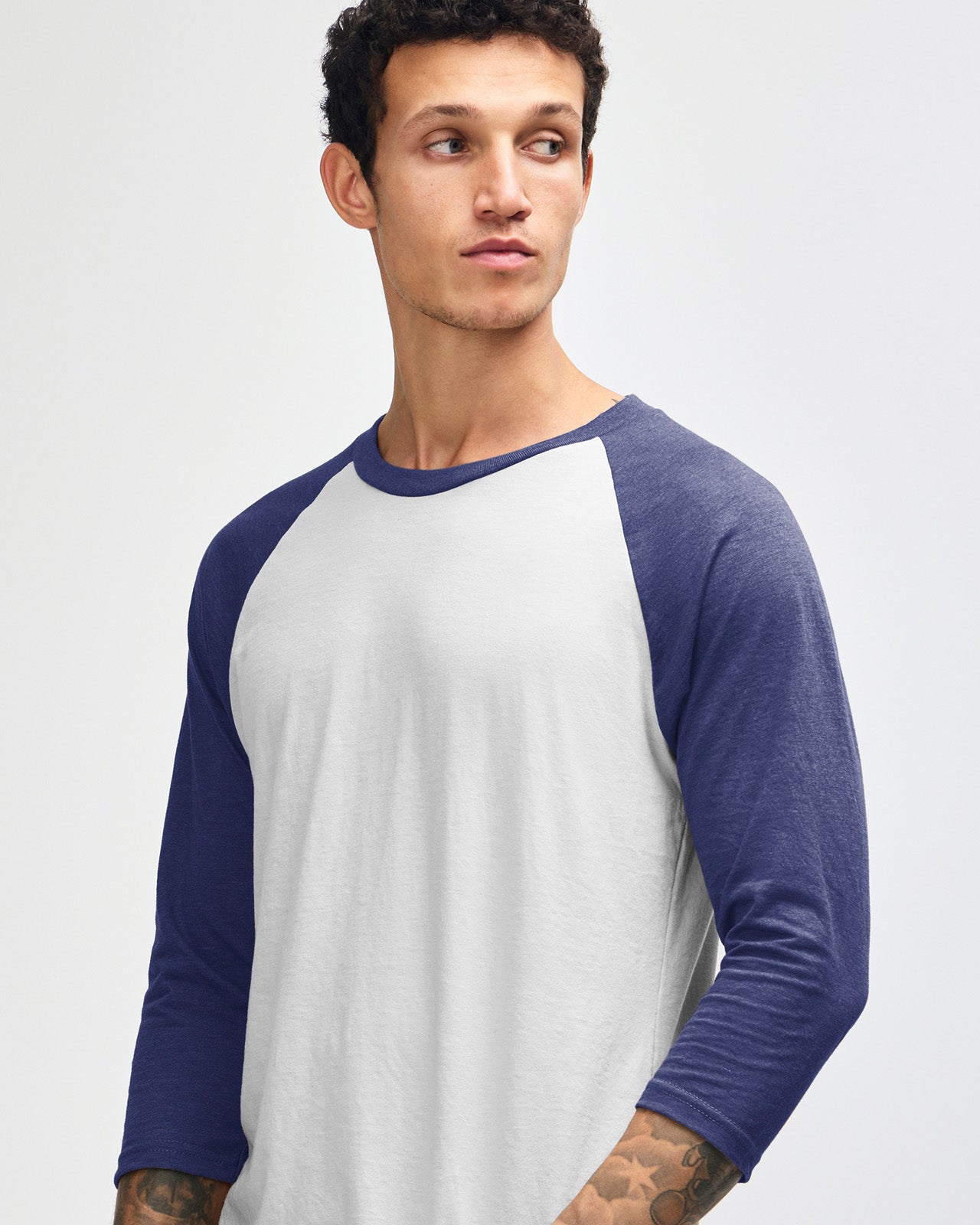 Male model wearing Heather Indigo American Apparel CVC unisex raglan Tee (front pose) -heather indigo 