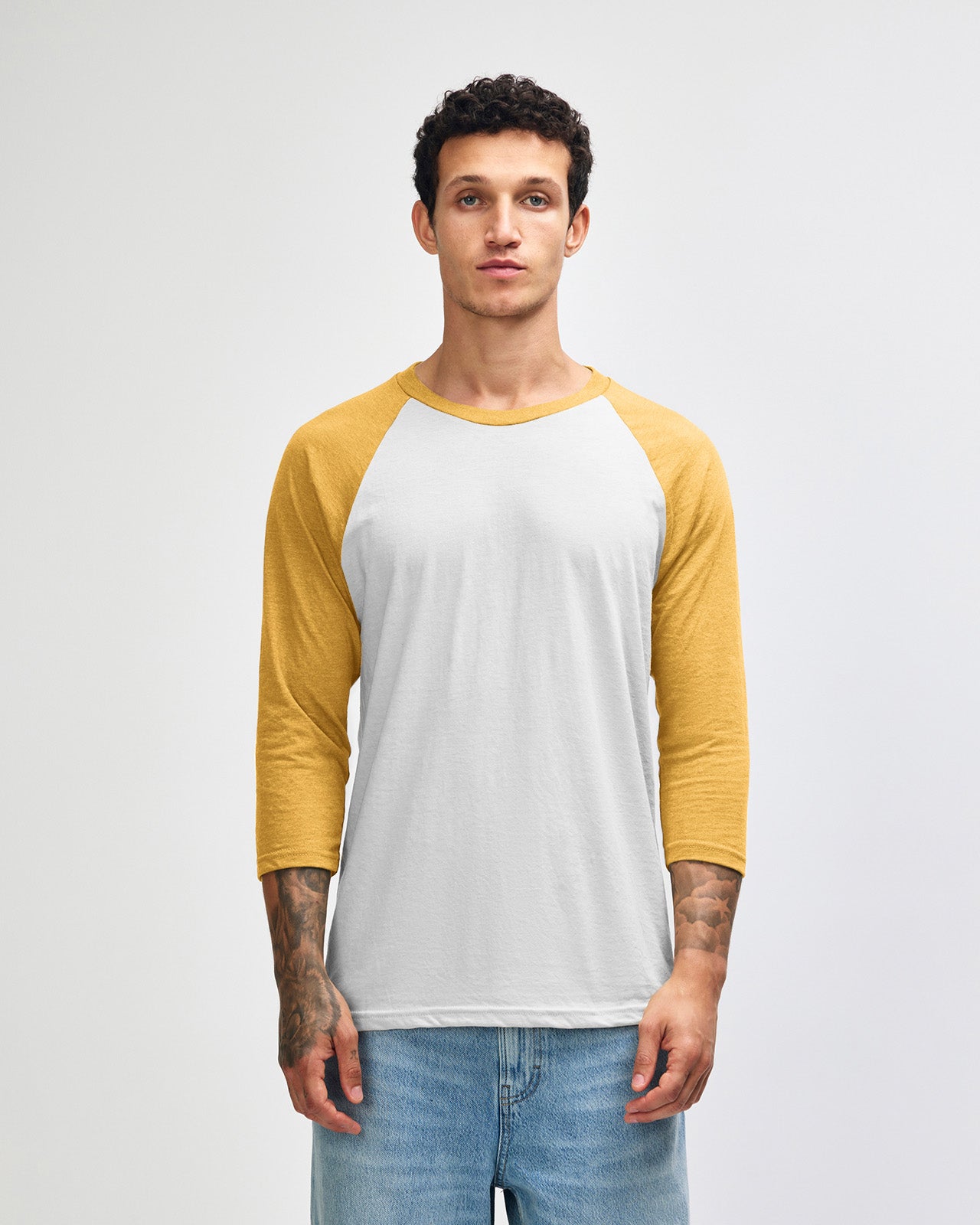 Male model wearing American Apparel CVC unisex raglan Tee (front pose) - heather mustard