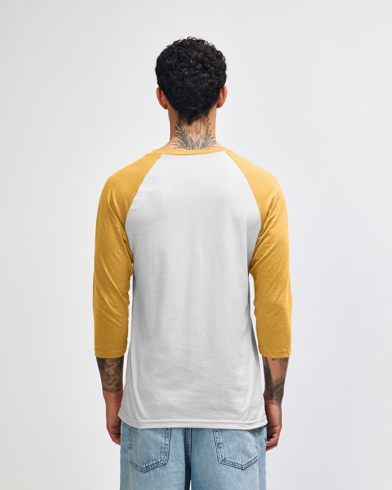 Male model wearing American Apparel CVC unisex raglan Tee (front pose) - heather mustard