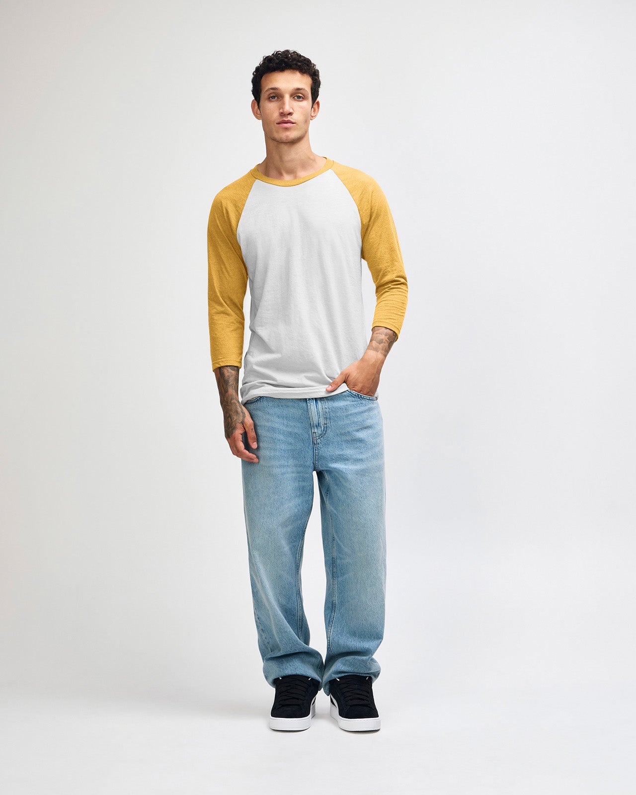 Male model wearing American Apparel CVC unisex raglan Tee (front pose) - heather mustard