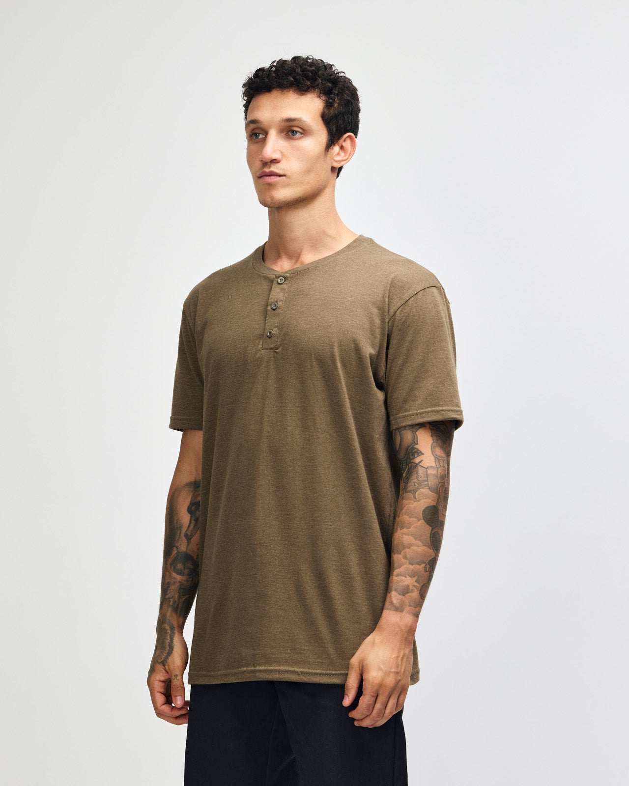 Male model wearing heather army Unisex Henley Tee (front pose) -heather army