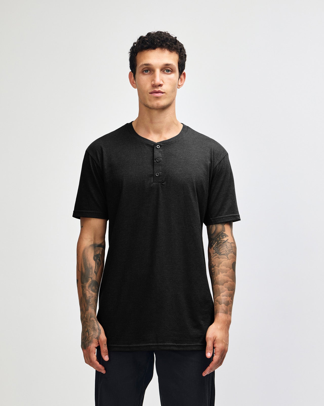 Male model wearing black colour Unisex Henley Tee (front pose) -black
