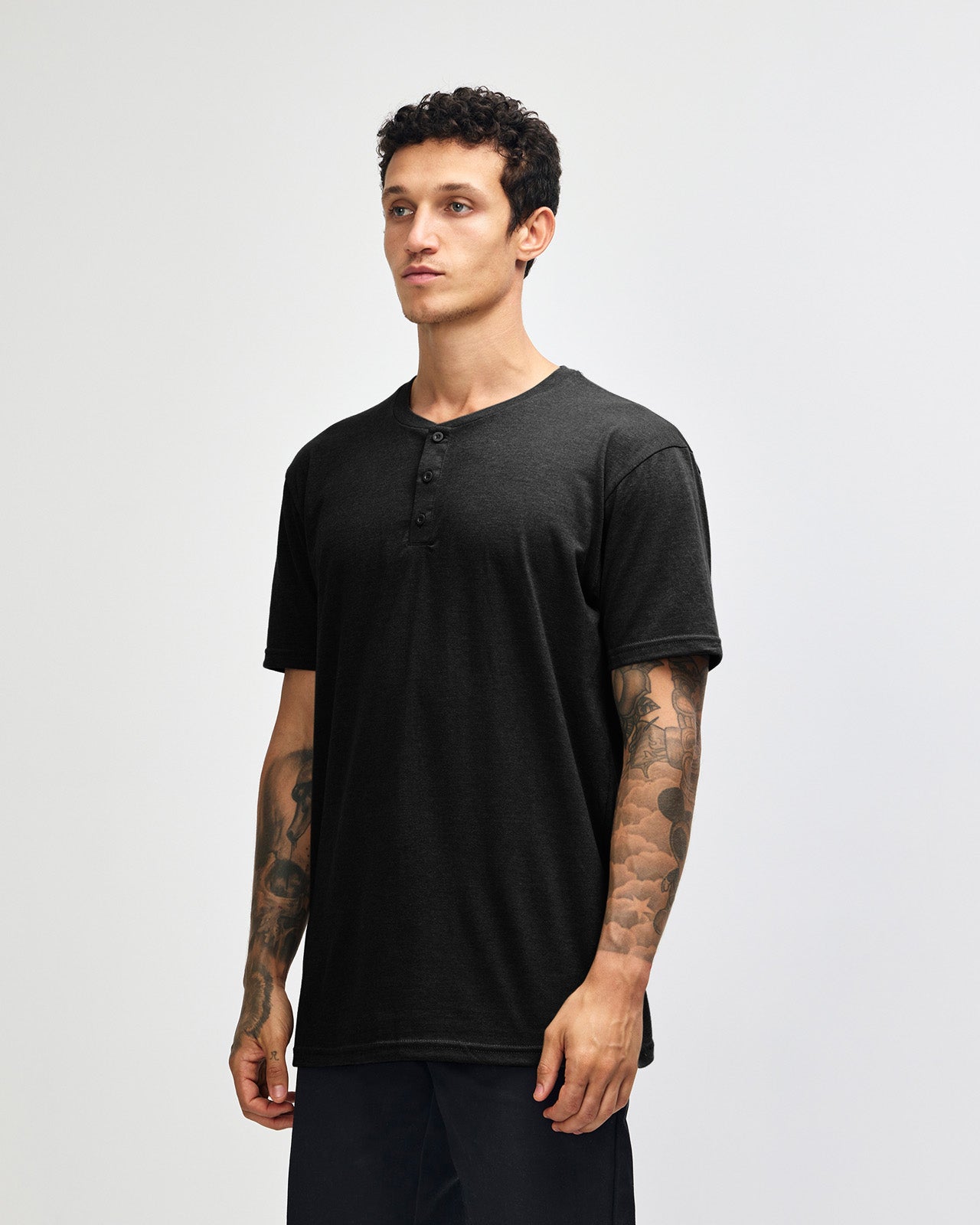 Male model wearing black colour Unisex Henley Tee (front pose) -black