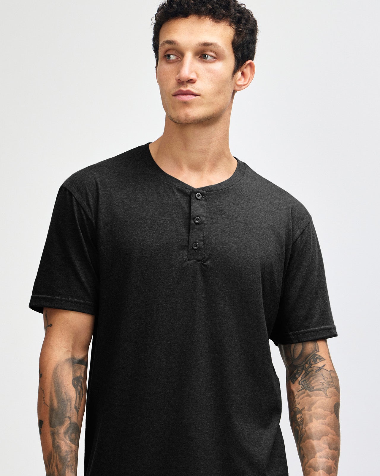 Male model wearing black colour Unisex Henley Tee (front pose) -black