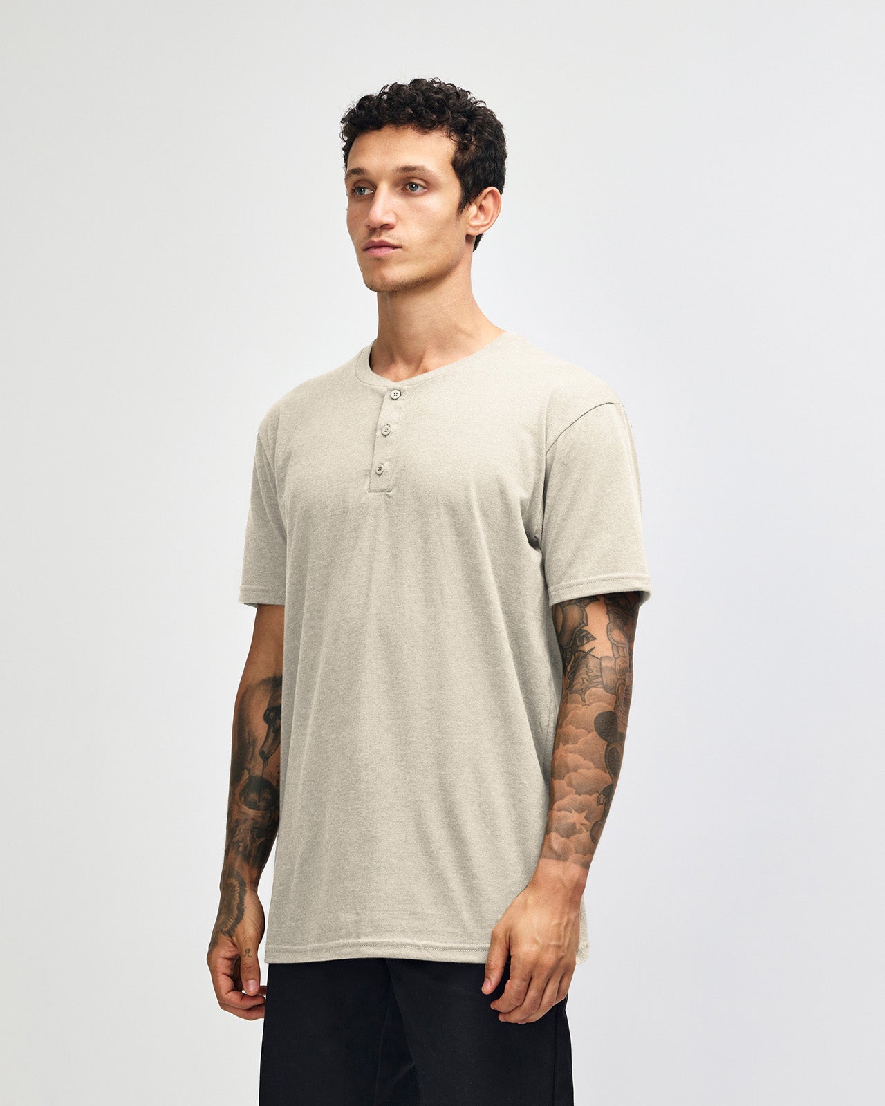 Male model wearing Heather Bone colour Unisex Henley Tee (front pose) -heather bone