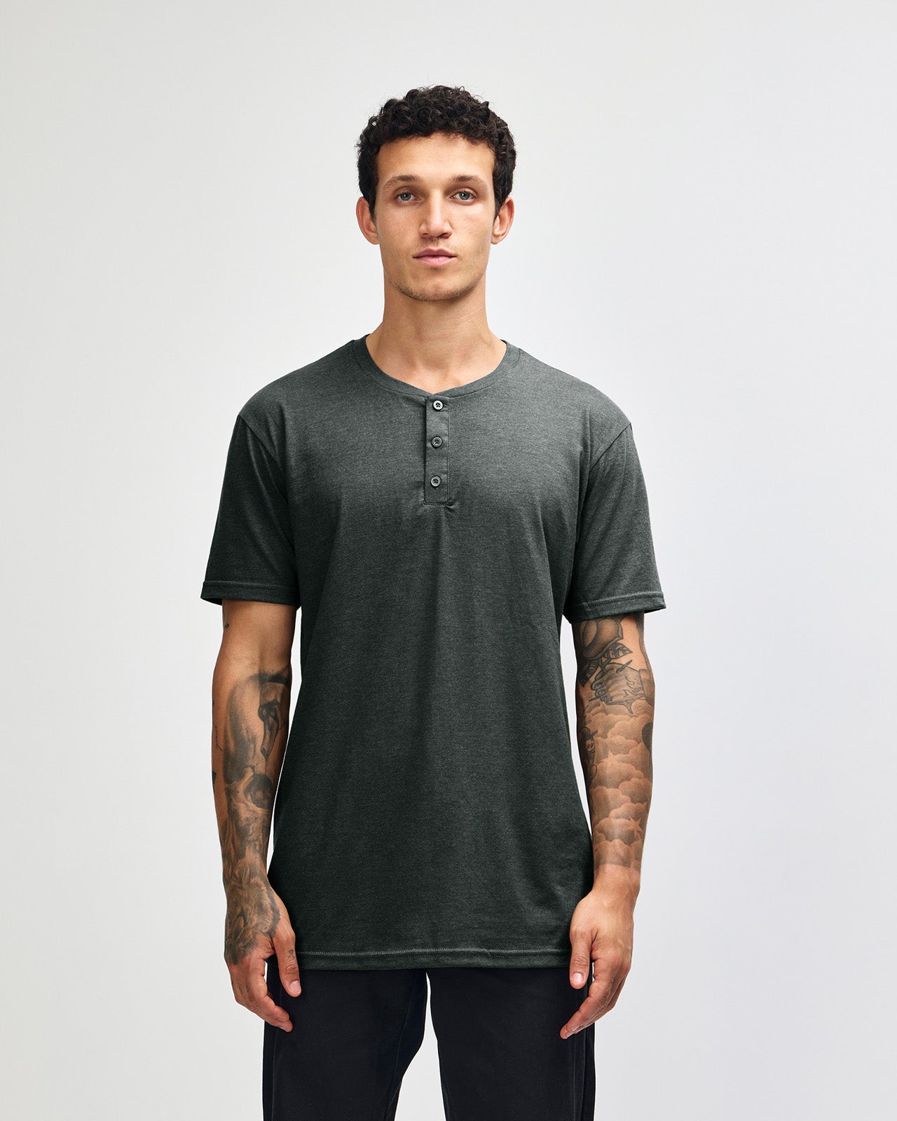 Male model wearing heather charcoal Unisex Henley Tee (front pose) -heather charcoal