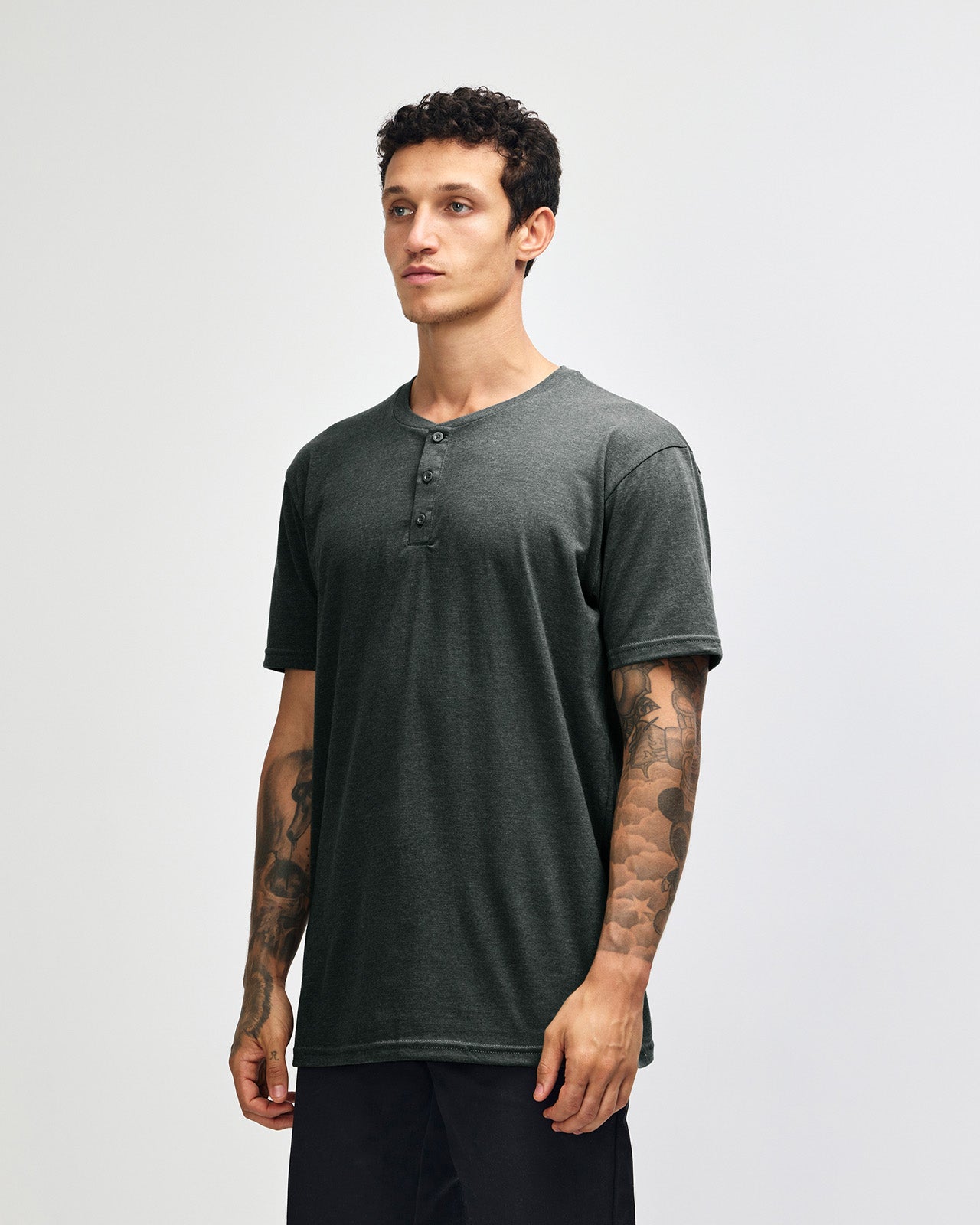 Male model wearing heather charcoal Unisex Henley Tee (front pose) -heather charcoal