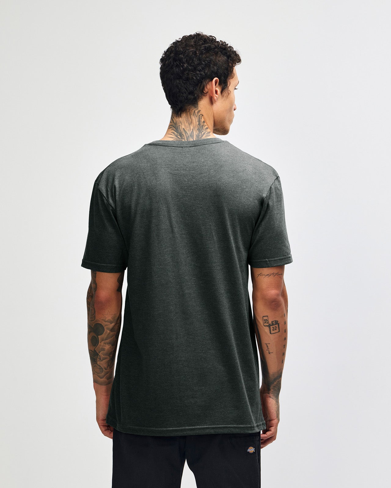 Male model wearing heather charcoal Unisex Henley Tee (back pose) -heather charcoal