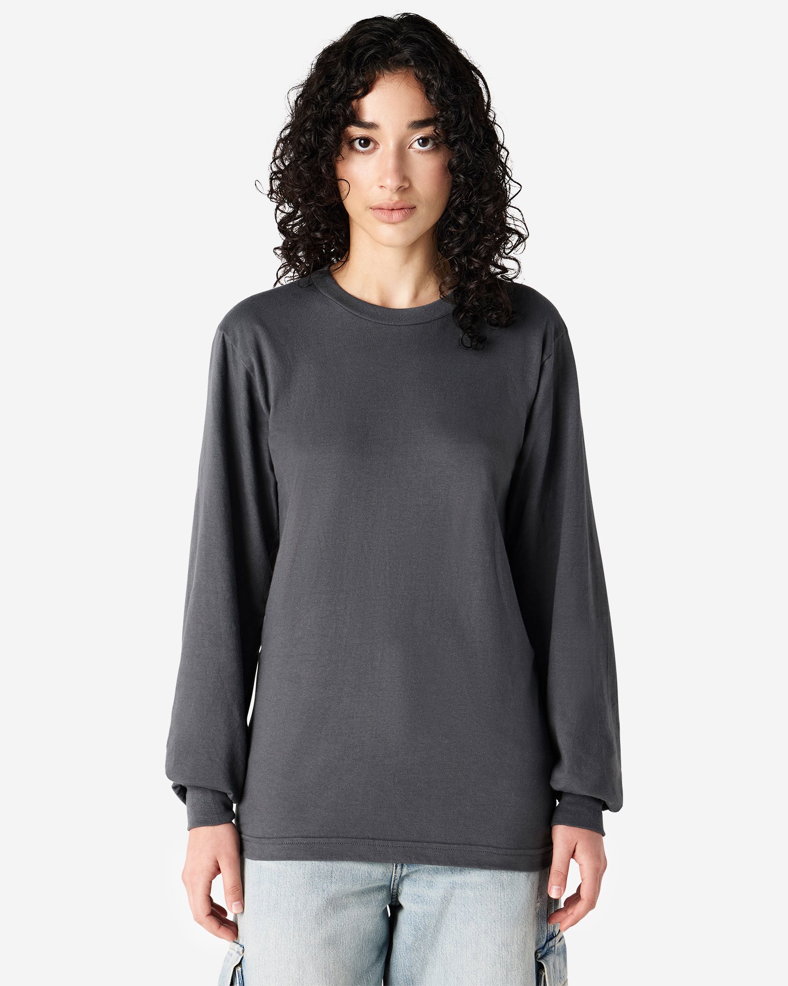Female model wearing American Apparel Asphalt Colour Fine Jersey Unisex Long Sleeve Crew Neck Tee (Front pose) -asphalt