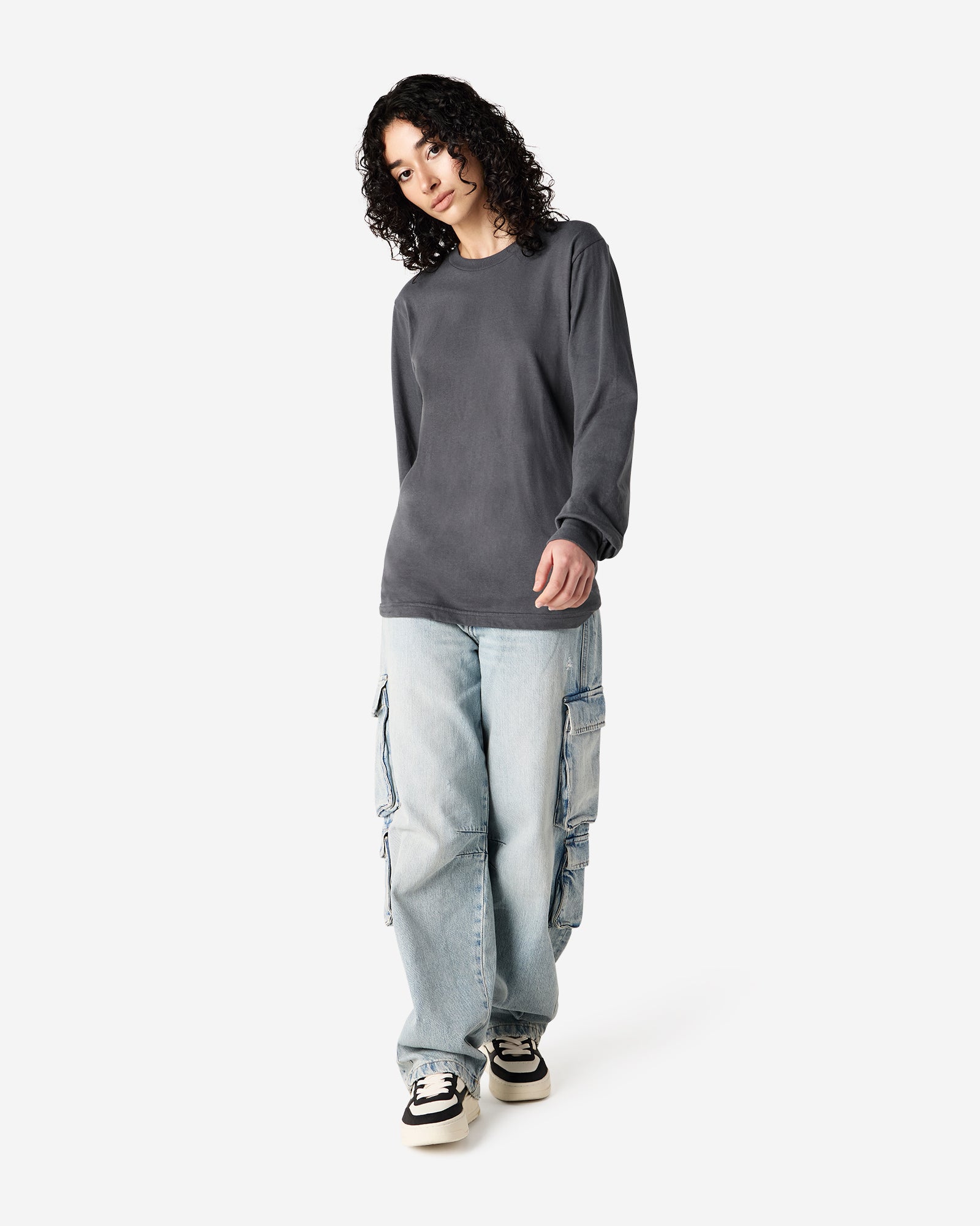 Female model wearing American Apparel Asphalt Colour Fine Jersey Unisex Long Sleeve Crew Neck Tee (Full length pose) -asphalt