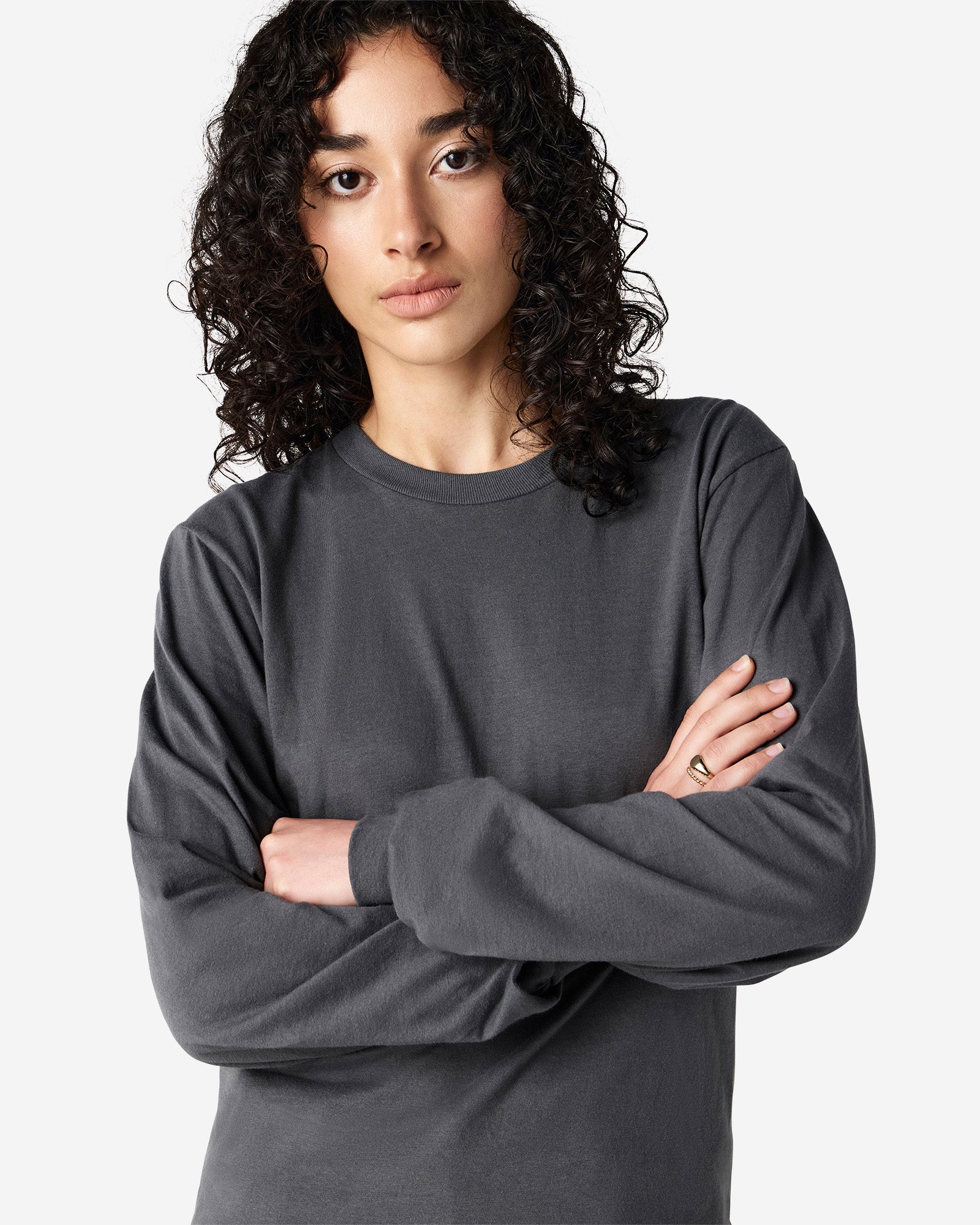 Female model wearing American Apparel Asphalt Colour Fine Jersey Unisex Long Sleeve Crew Neck Tee (Close up pose) -asphalt