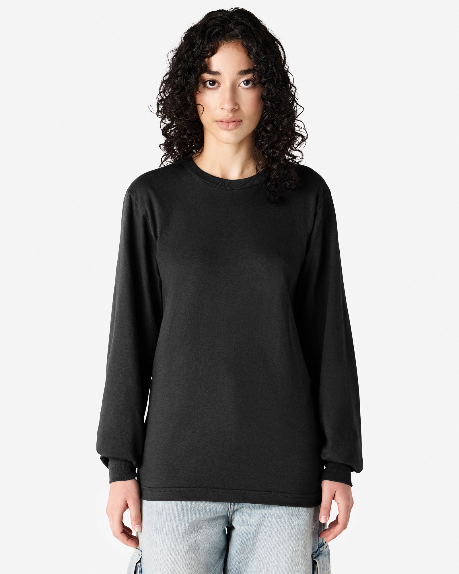 Female model wearing American Apparel Black Colour Fine Jersey Unisex Long Sleeve Crew Neck Tee (Front pose) -black