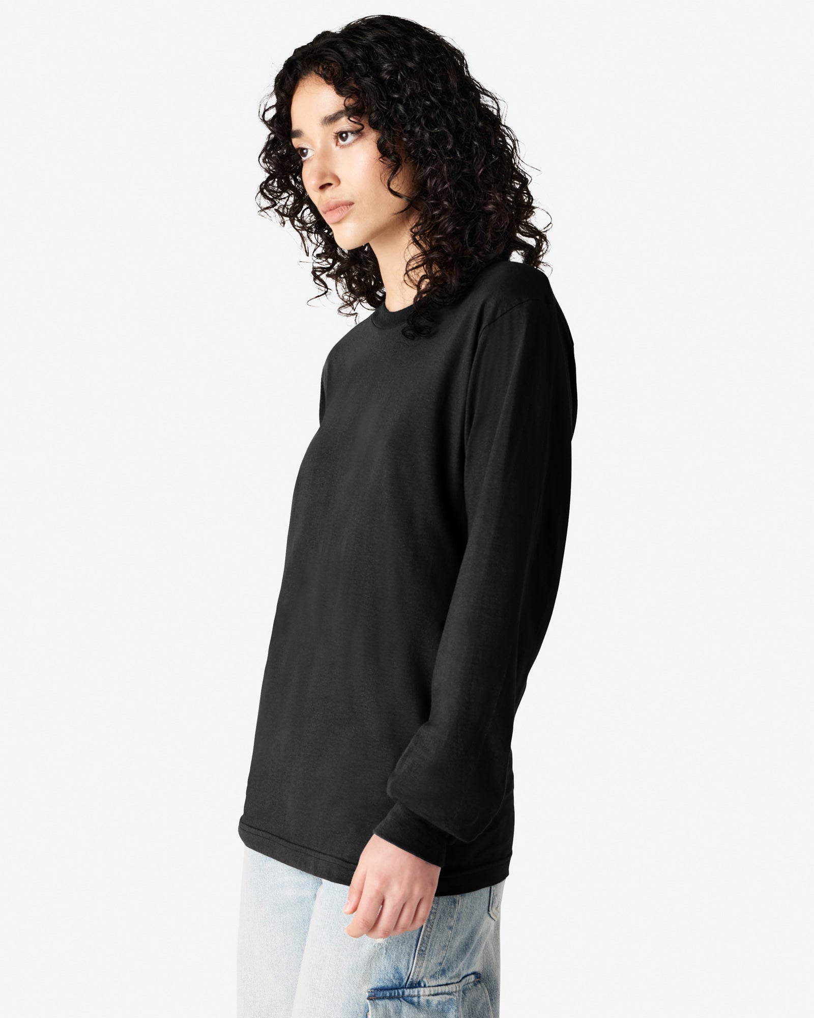 Female model wearing American Apparel Black Colour Fine Jersey Unisex Long Sleeve Crew Neck Tee (half Front pose) -black