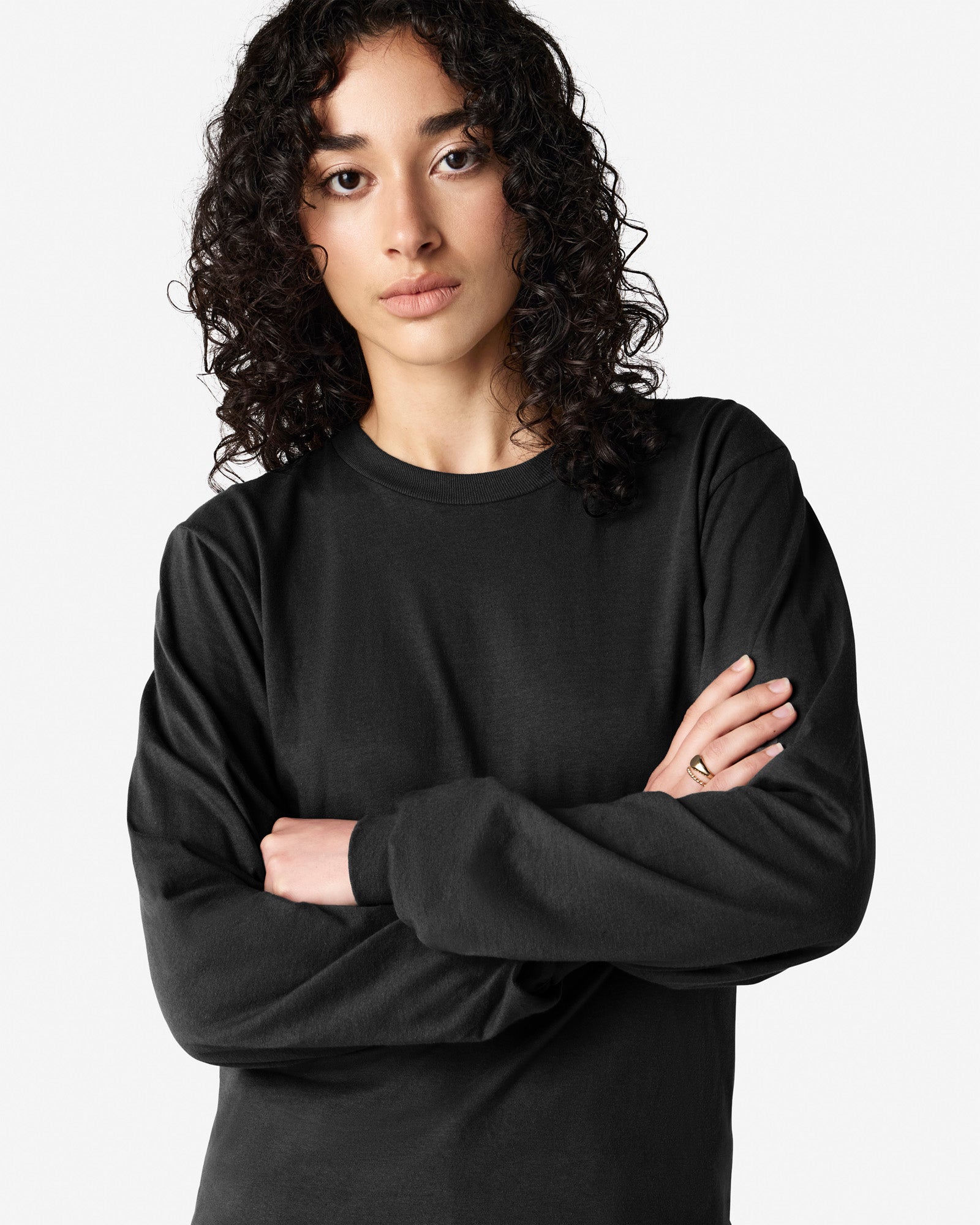 Female model wearing American Apparel Black Colour Fine Jersey Unisex Long Sleeve Crew Neck Tee (half Front pose) -black