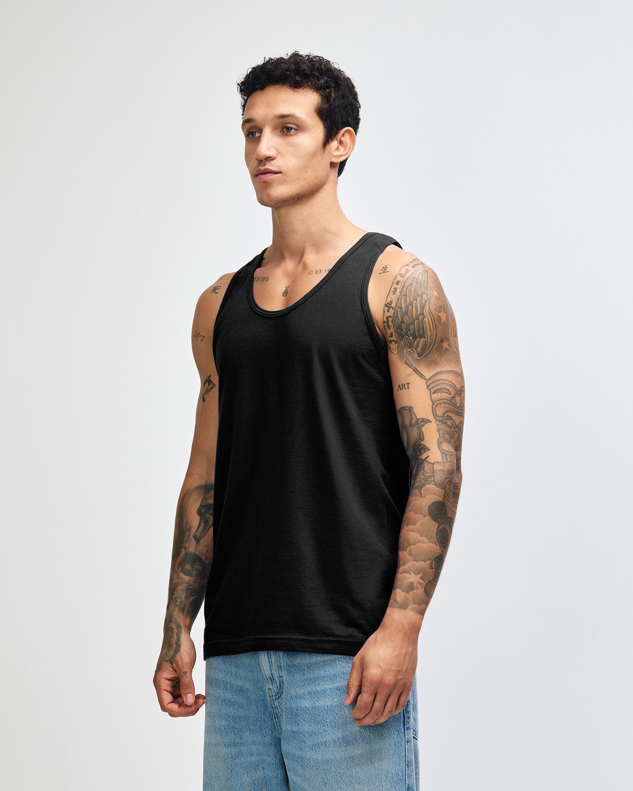 Male model wearing asphalt colour American Apparel Fine Jersey Unisex Tank Top (front pose) -black