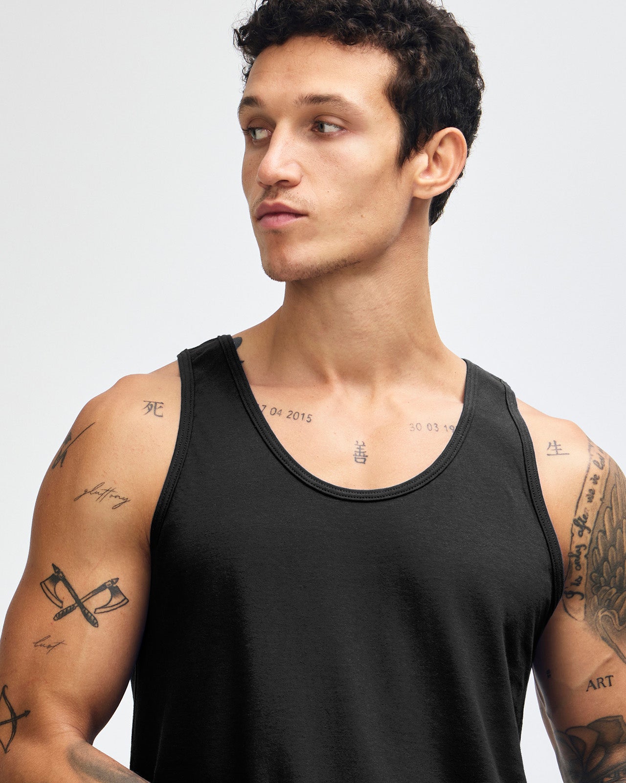 Male model wearing asphalt colour American Apparel Fine Jersey Unisex Tank Top (front pose) -black