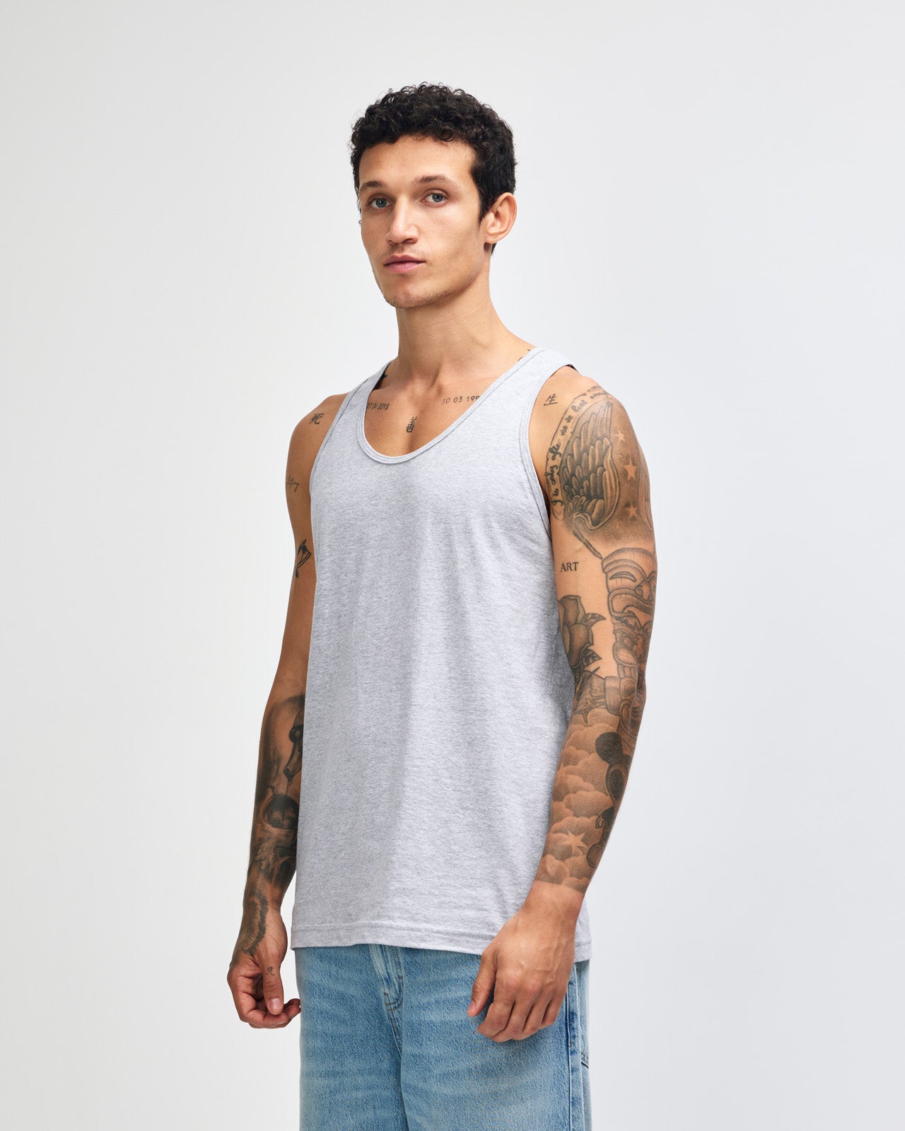 Male model wearing heather grey colour American Apparel Fine Jersey Unisex Tank Top (front pose) -heather grey