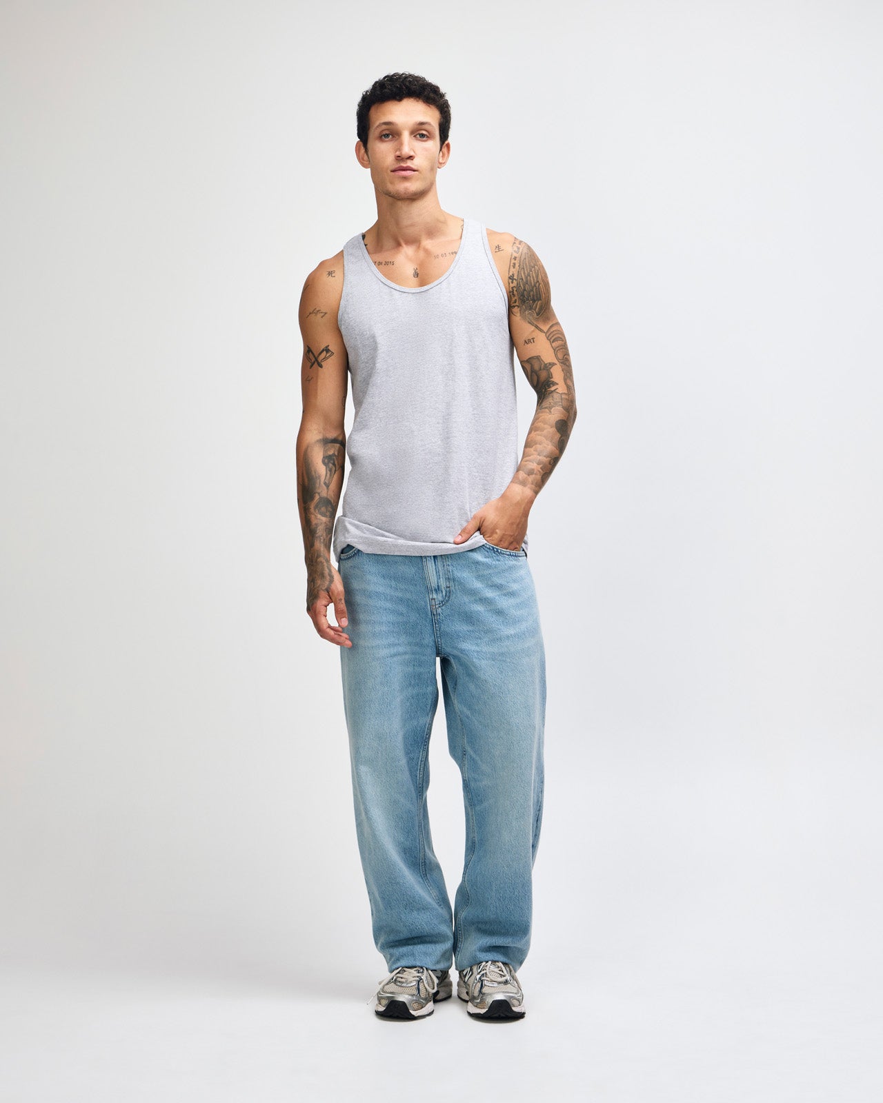 Male model wearing heather grey colour American Apparel Fine Jersey Unisex Tank Top (front pose) -heather grey