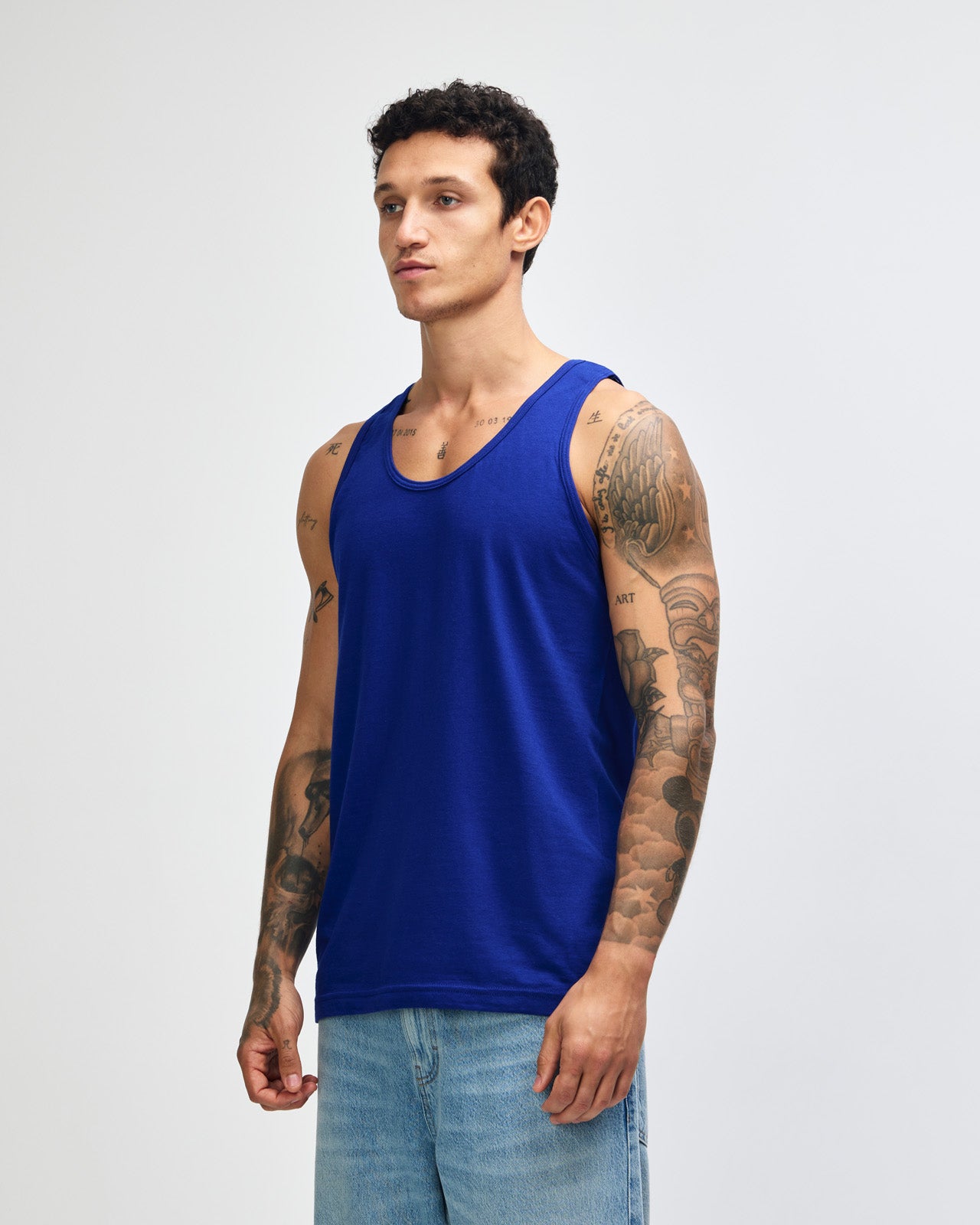 Male model wearing heather grey colour American Apparel Fine Jersey Unisex Tank Top (front pose) -lapis