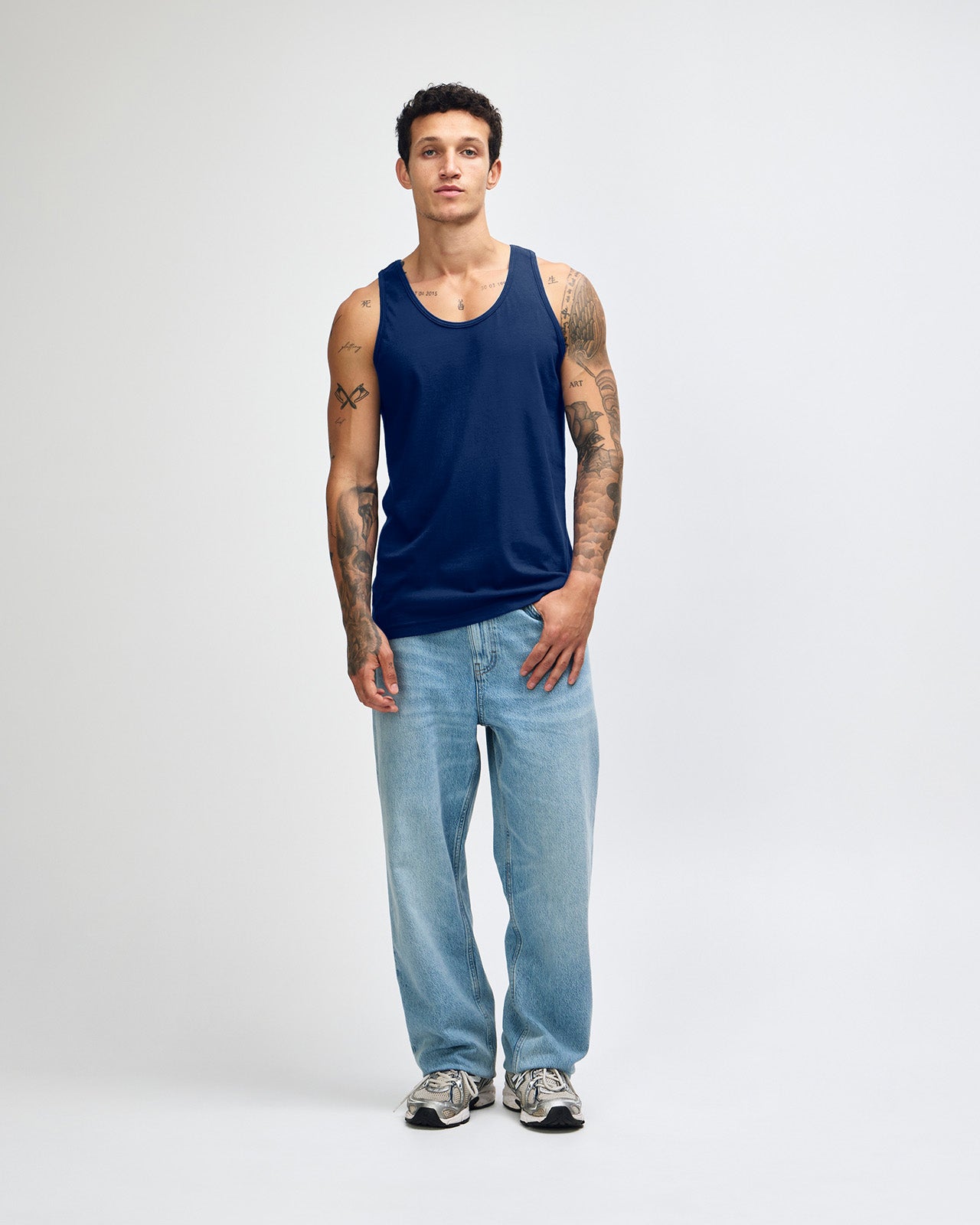 Male model wearing navy colour American Apparel Fine Jersey Unisex Tank Top (front pose) -navy
