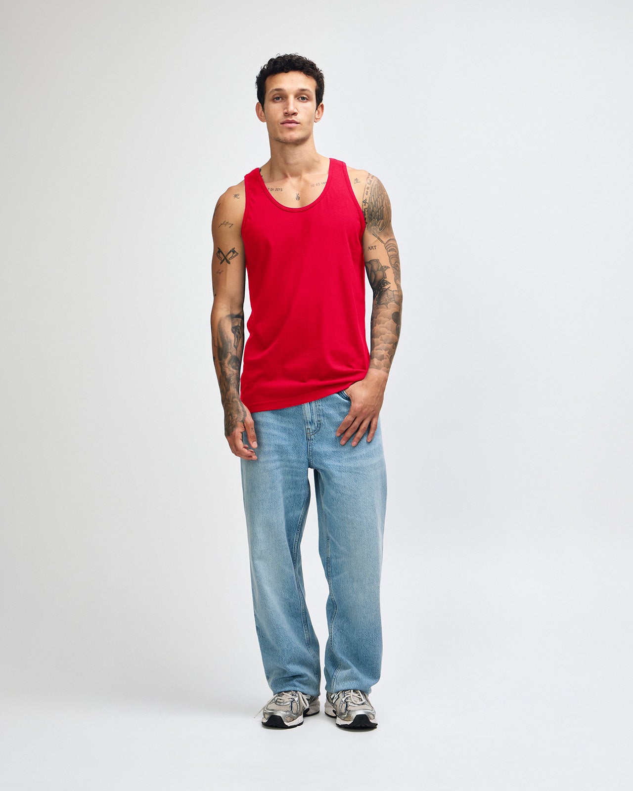 Male model wearing red colour American Apparel Fine Jersey Unisex Tank Top (front pose)-red