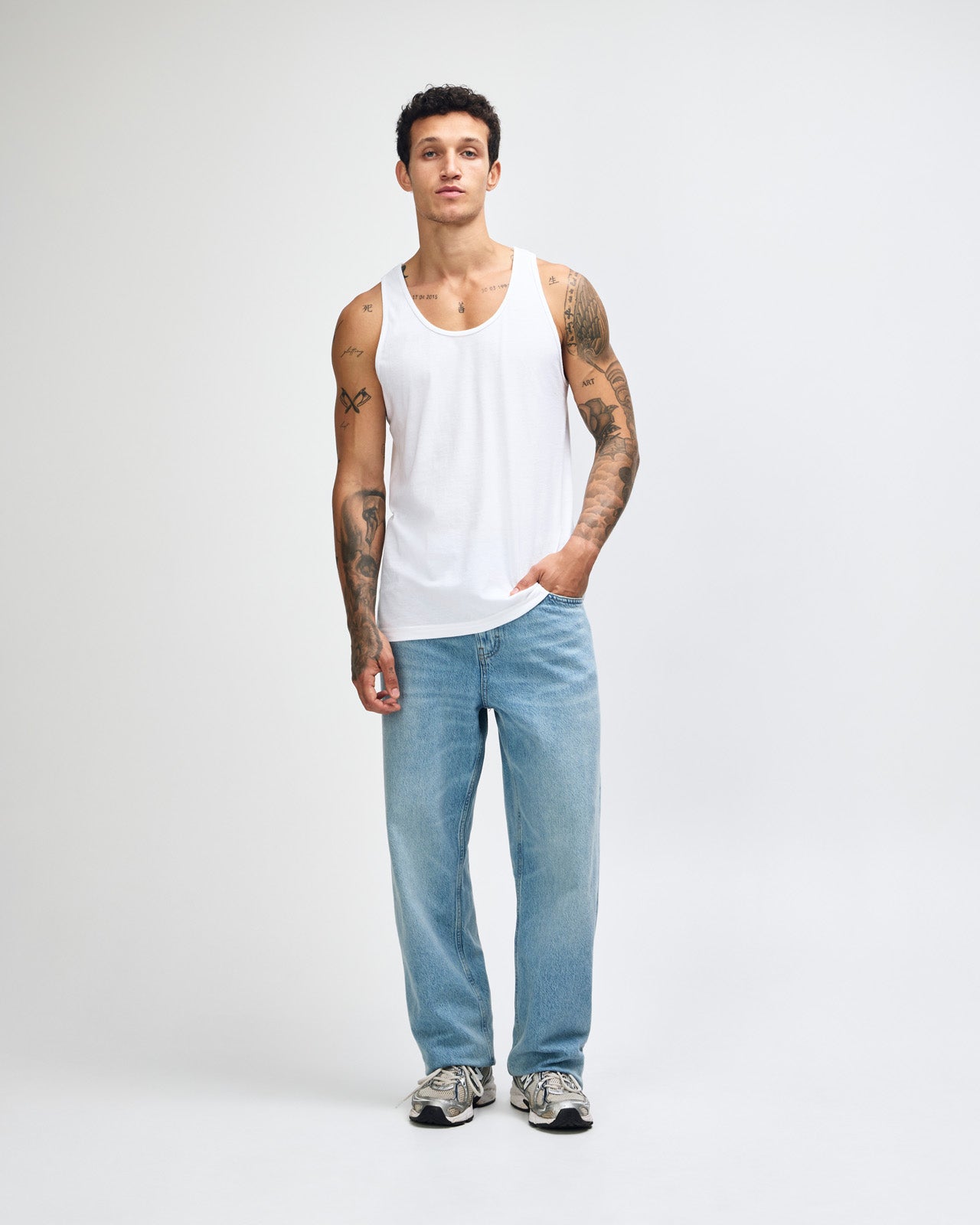 Male model wearing red colour American Apparel Fine Jersey Unisex Tank Top (front pose)-white