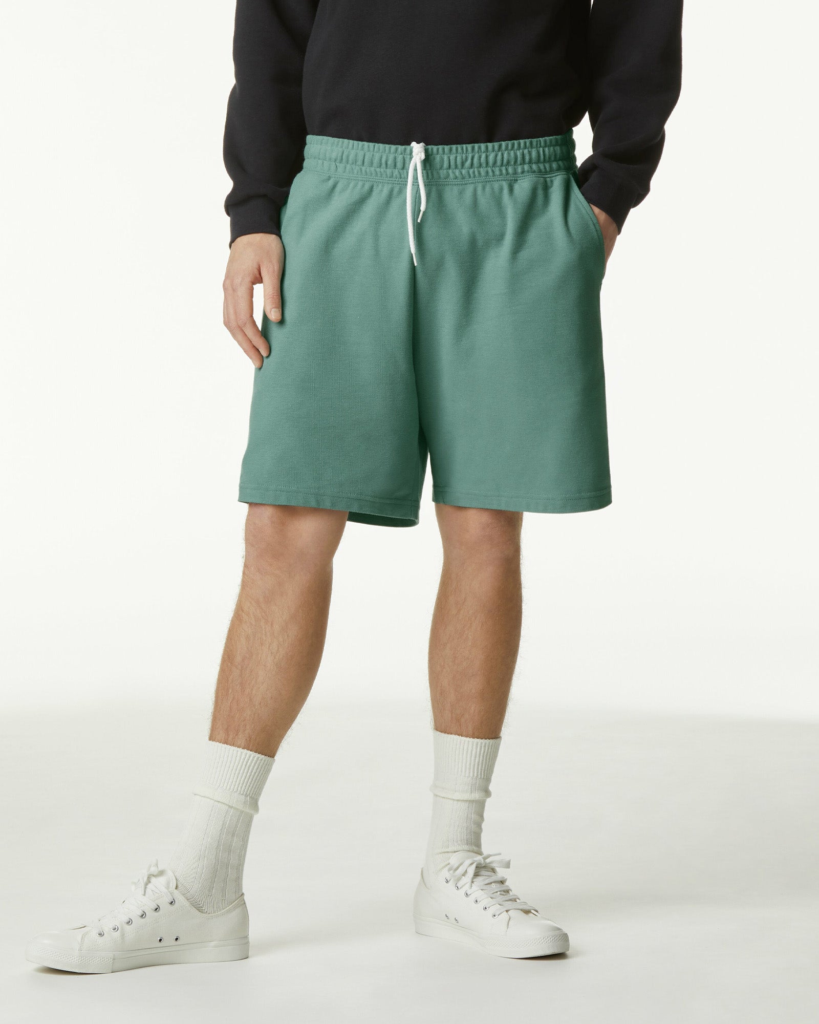 Model wearing a Pique Unisex Gym Shorts (front pose) -arctic