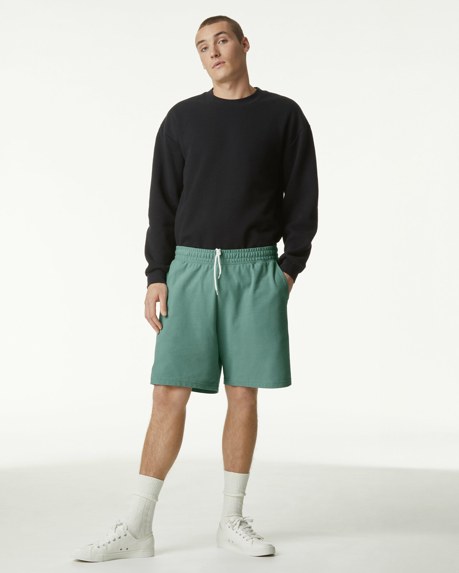 Model wearing a Pique Unisex Gym Shorts (front pose) -arctic
