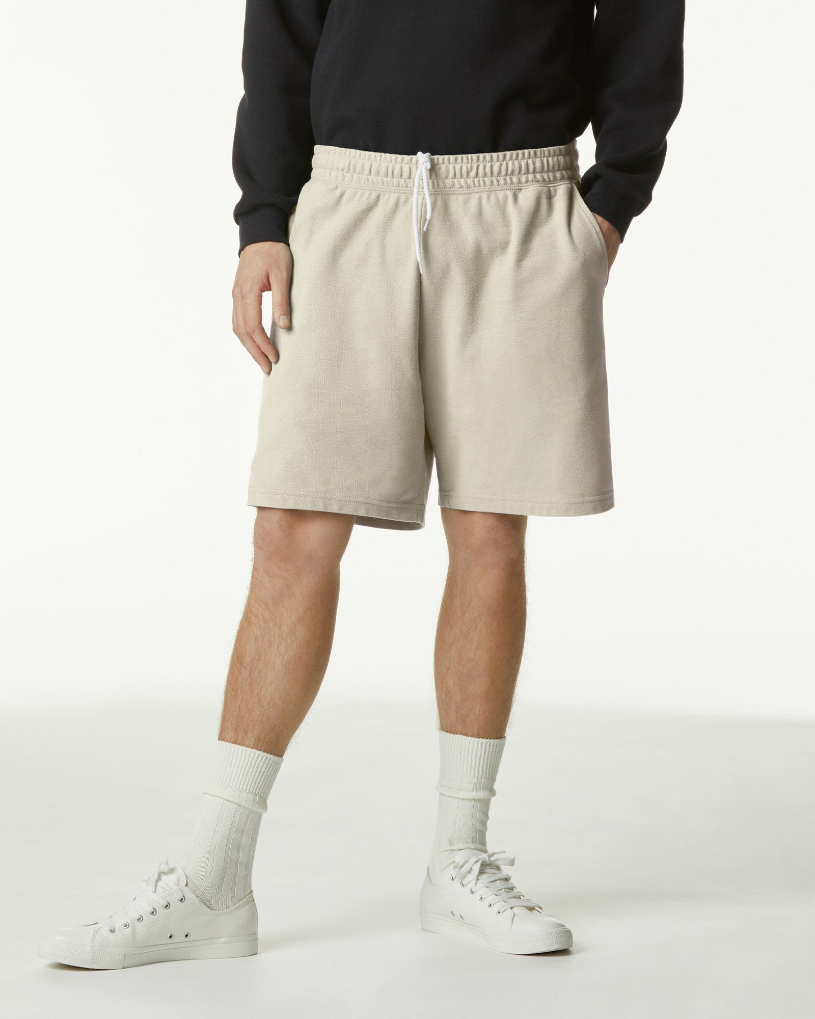 Model wearing a Pique Unisex Gym Shorts (front pose) -bone