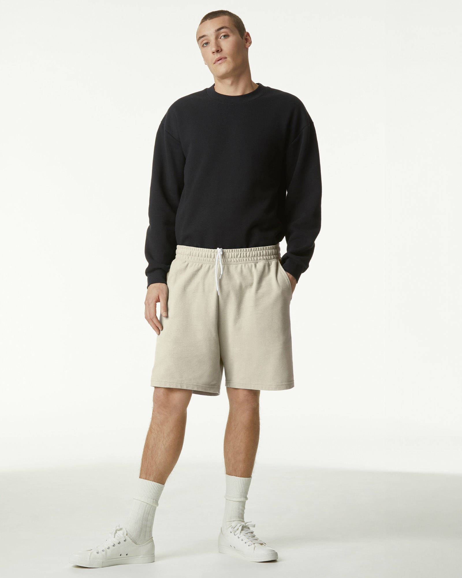 Model wearing a Pique Unisex Gym Shorts (front pose) -bone