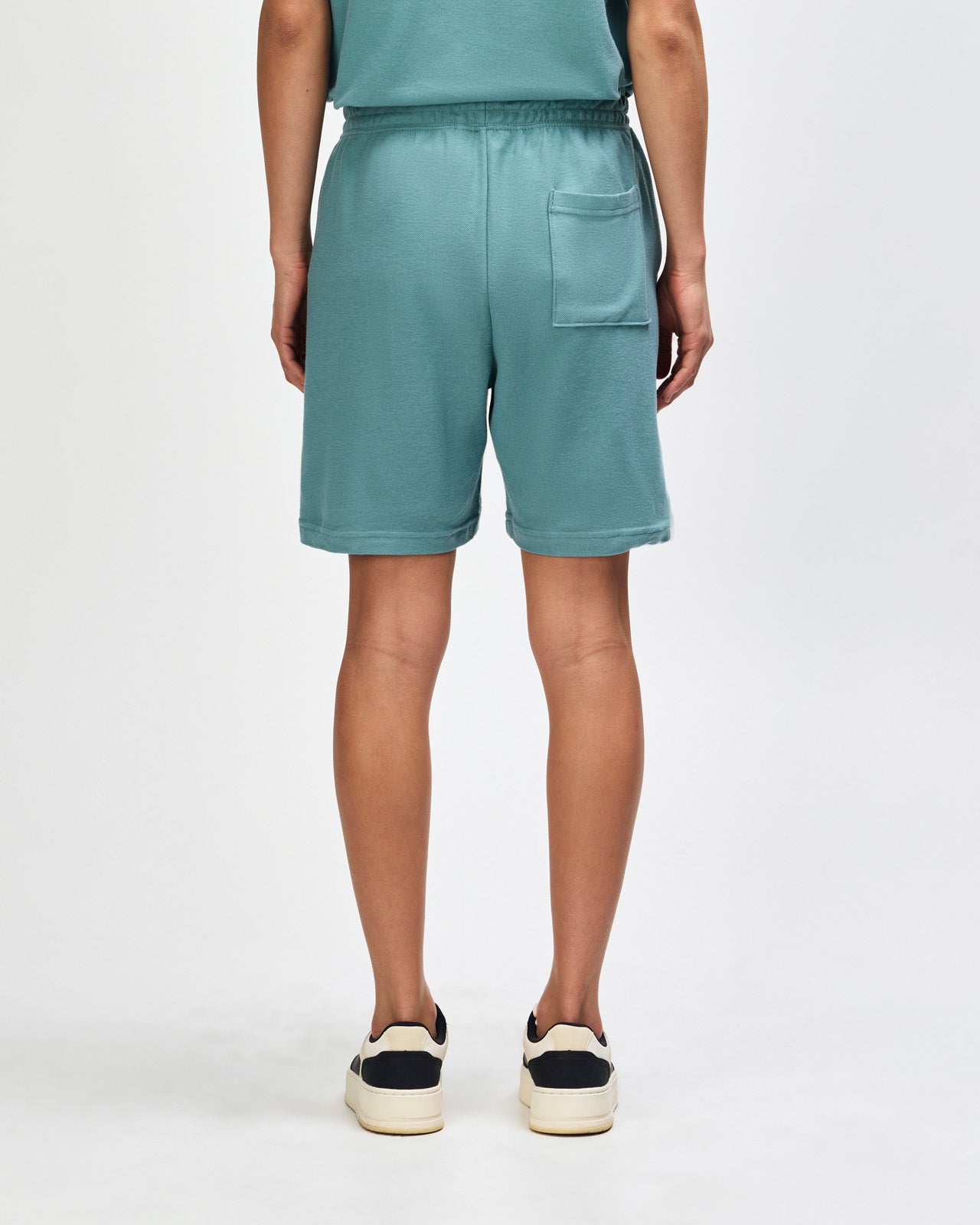 Model wearing a Pique Unisex Gym Shorts (front pose) -arctic