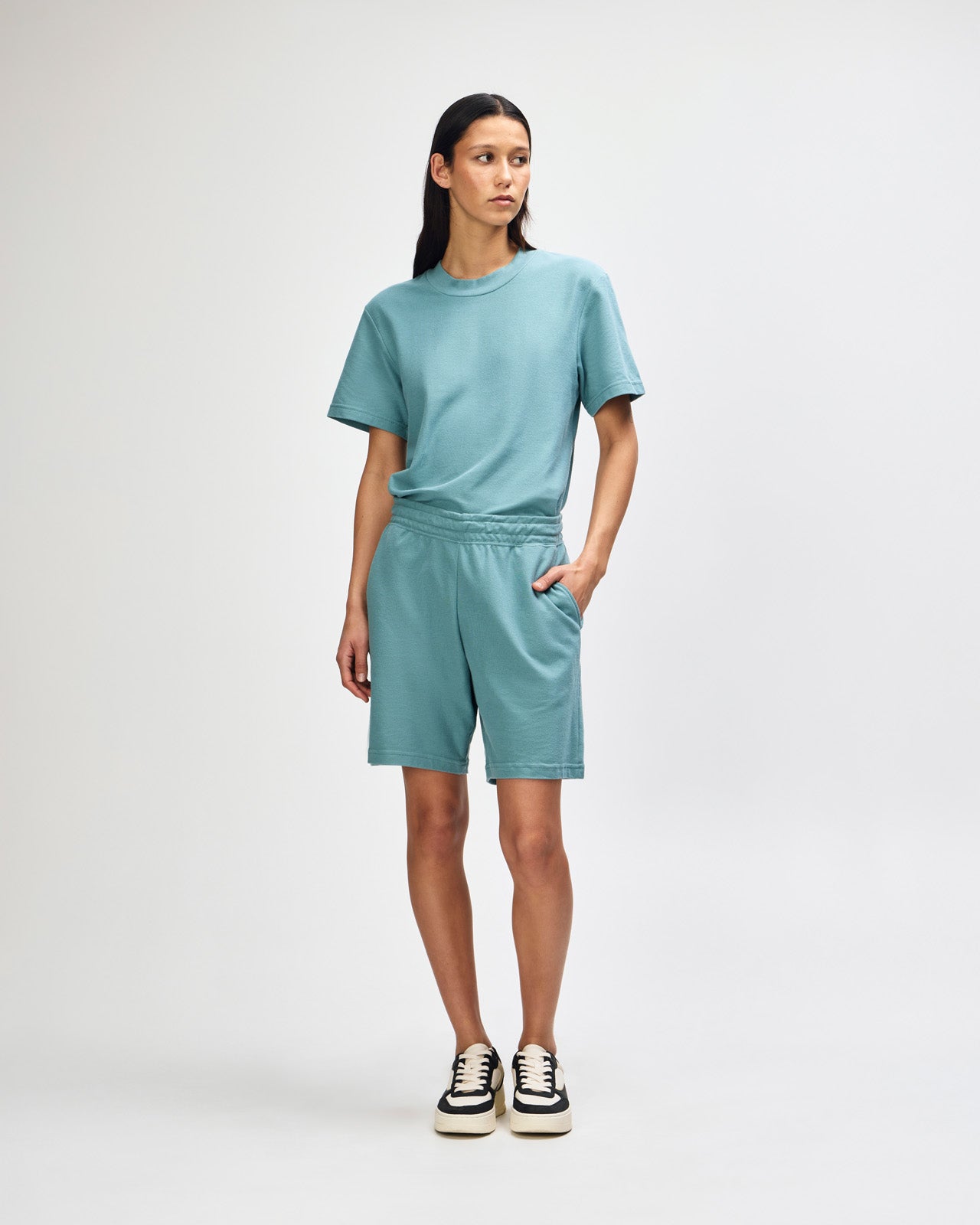 Model wearing a Pique Unisex Gym Shorts (front pose) -arctic