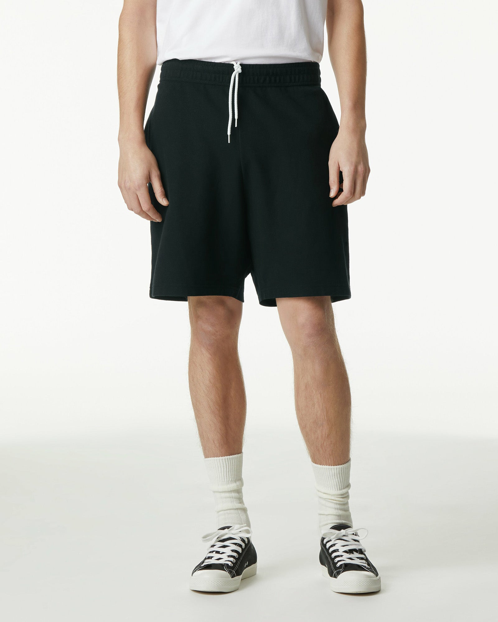 Model wearing a Pique Unisex Gym Shorts (front pose) -black
