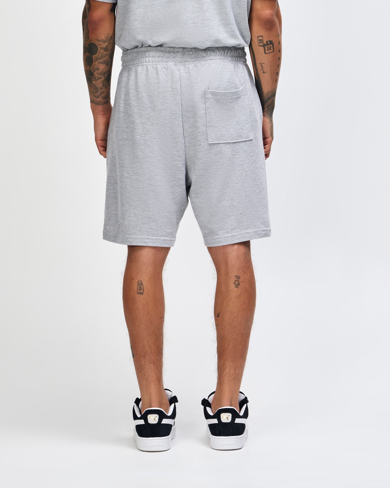 Model wearing a Pique Unisex Gym Shorts (front pose) -heather grey