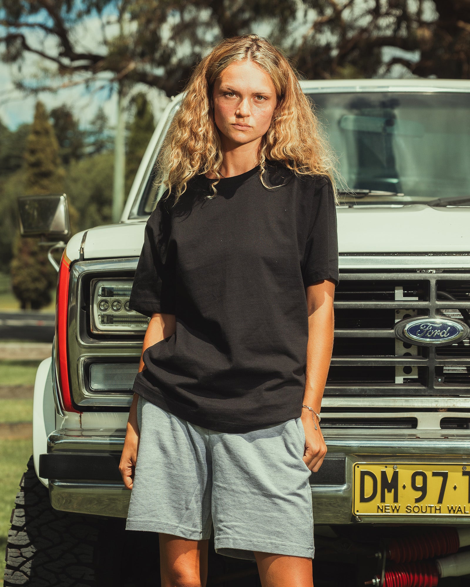 Model wearing a Pique Unisex Gym Shorts (front pose) -heather grey