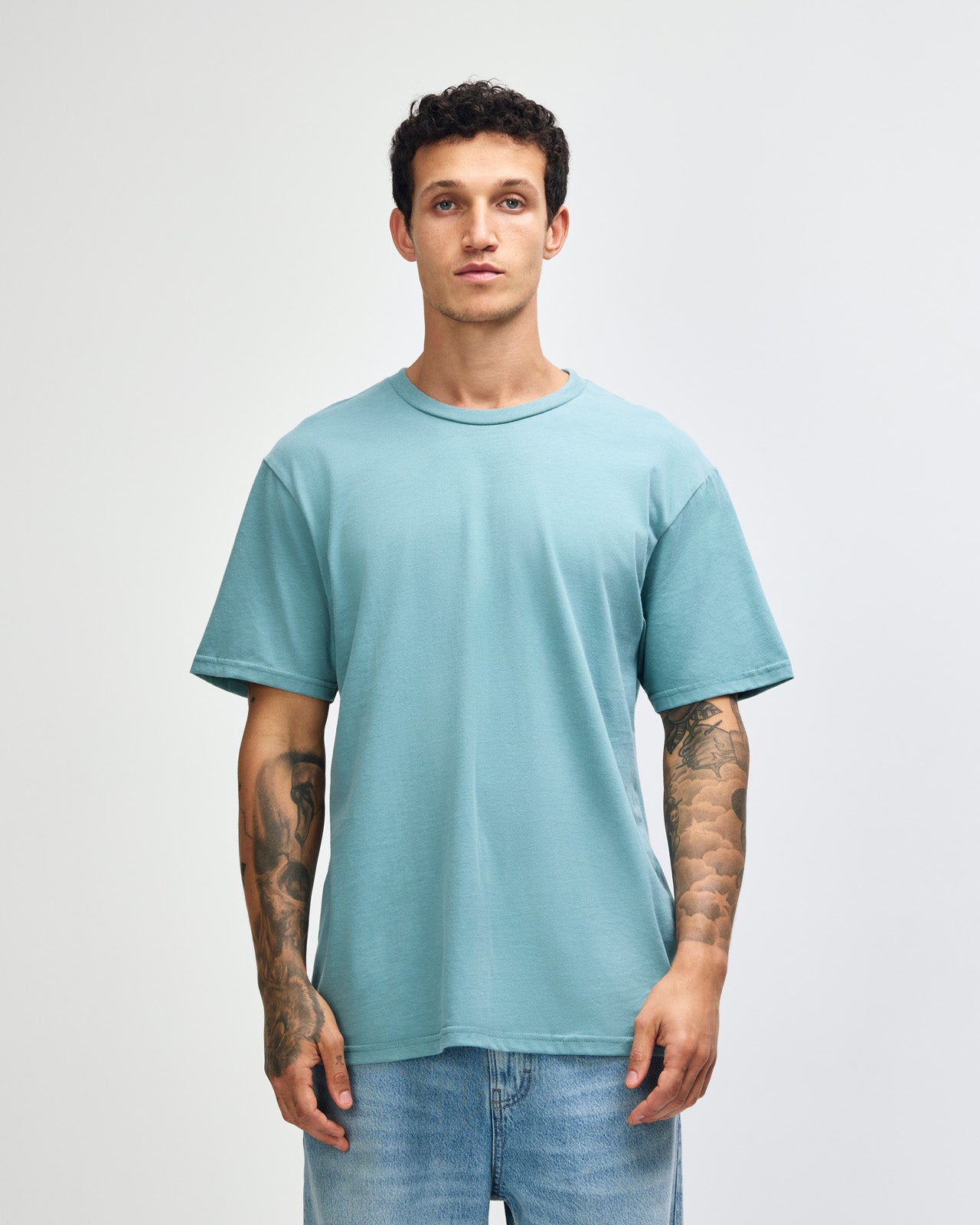Male model wearing sueded white colour  Unisex Short Sleeve Crew Neck Tee (front pose) -arctic