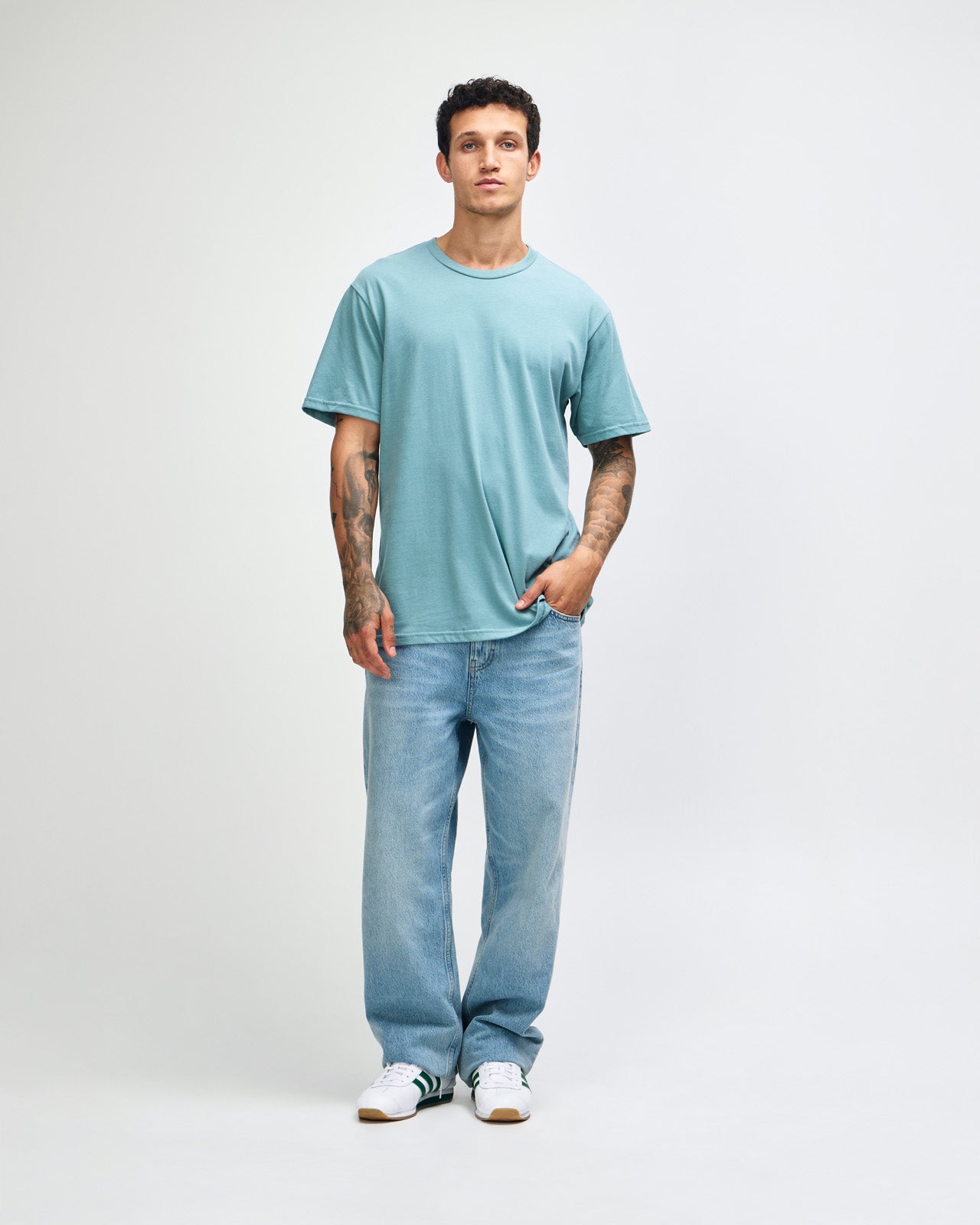 Male model wearing sueded white colour  Unisex Short Sleeve Crew Neck Tee (front pose) -arctic