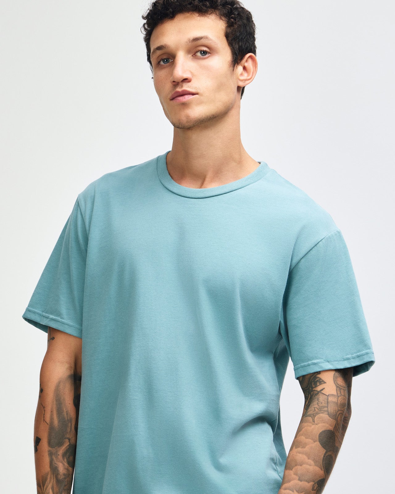 Male model wearing sueded white colour  Unisex Short Sleeve Crew Neck Tee (front pose) -arctic