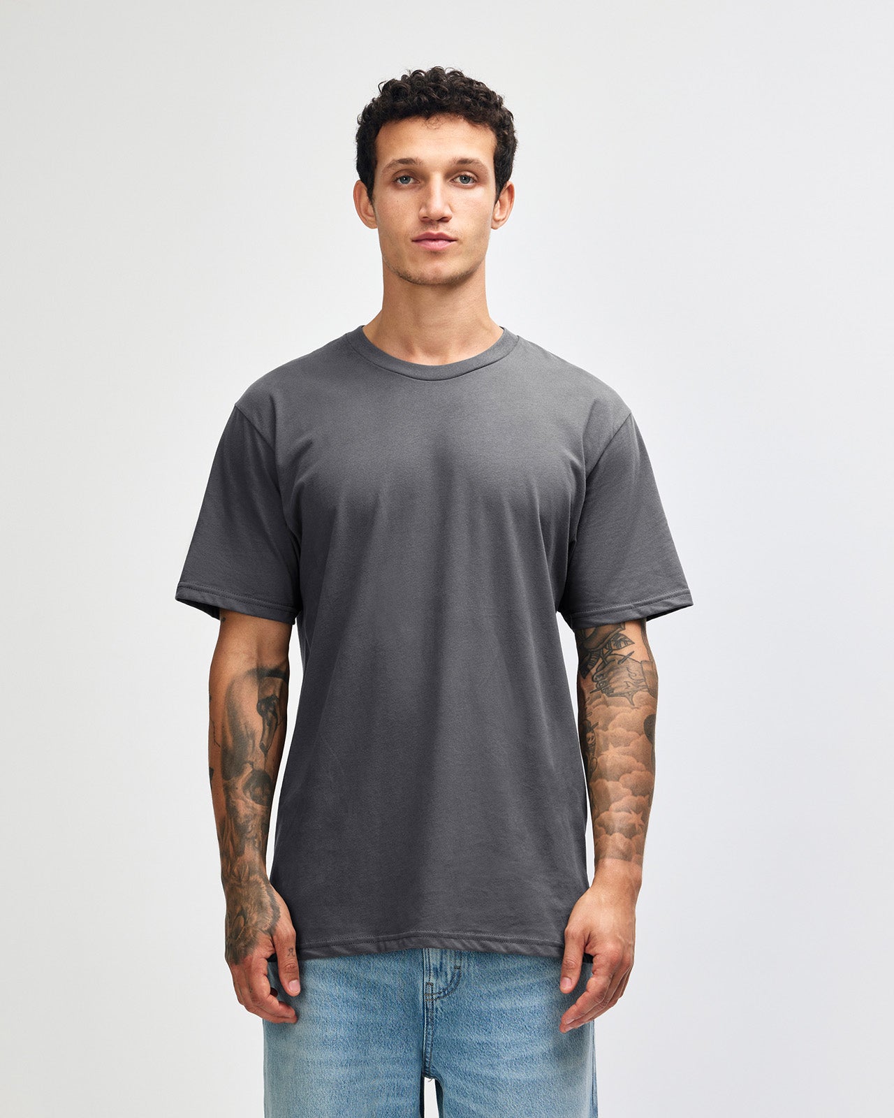 Male model wearing sueded white colour  Unisex Short Sleeve Crew Neck Tee (front pose) -asphalt