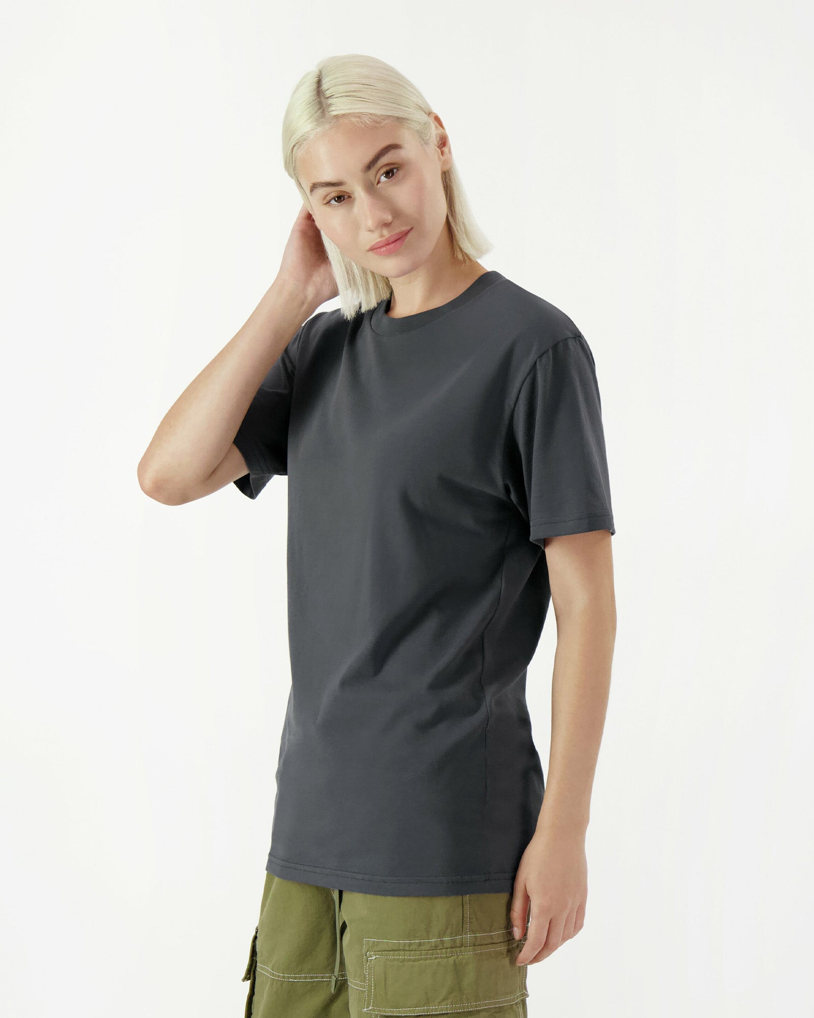 Female model wearing a Sueded Unisex Short Sleeve Tee (side pose) -asphalt