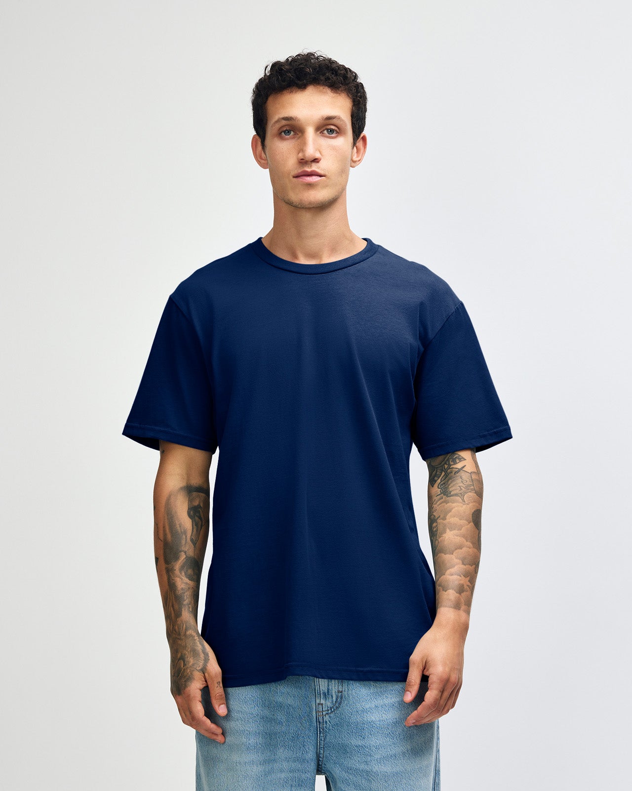 Male model wearing sueded white colour  Unisex Short Sleeve Crew Neck Tee (front pose) -navy